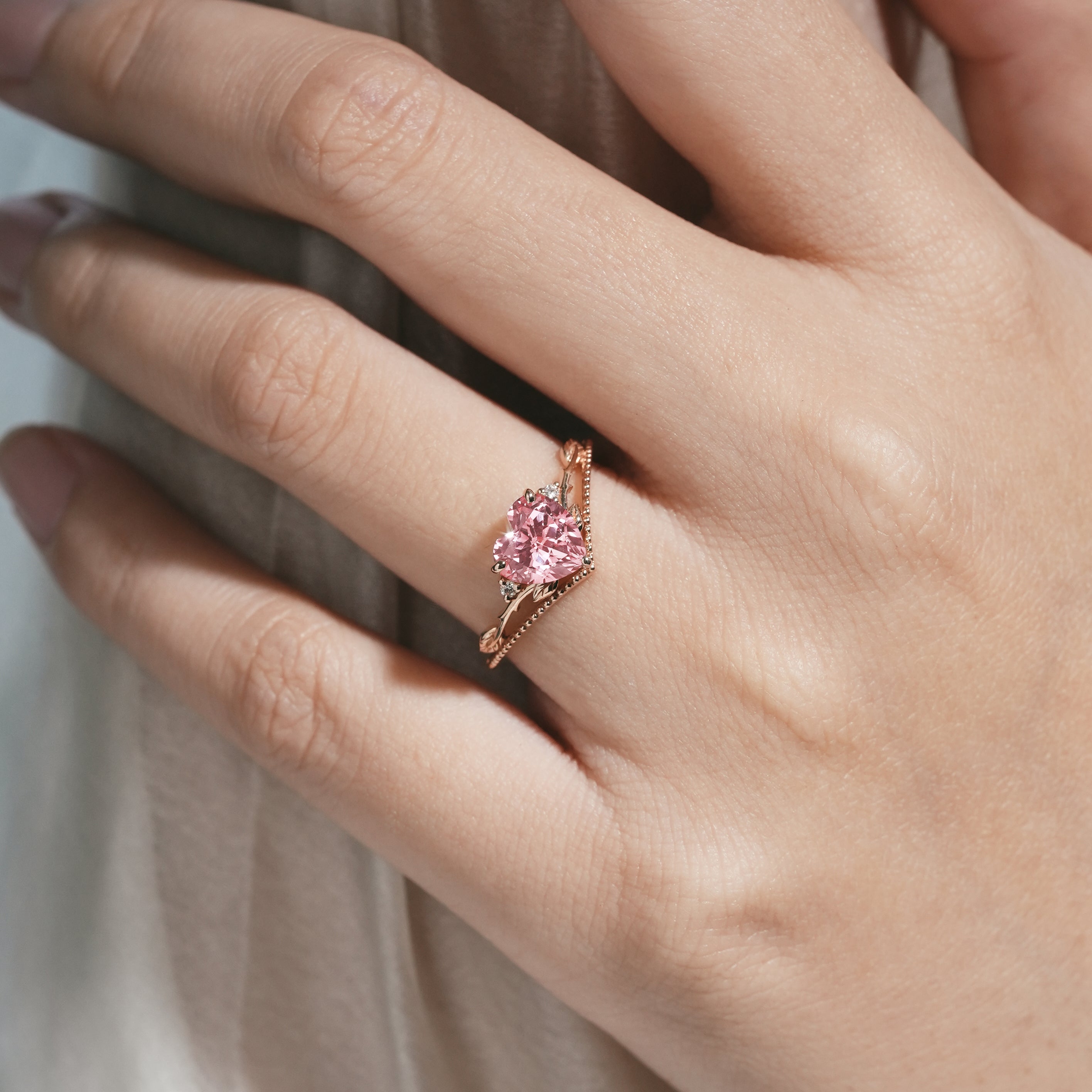 Rose gold engagement ring with heart-shaped Padparadscha sapphire