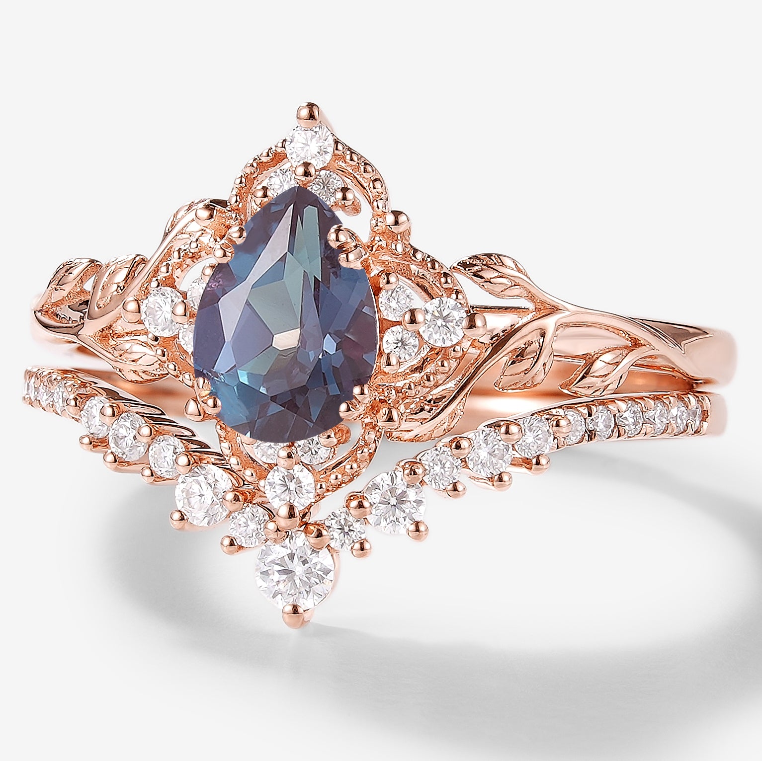 Rose gold pear-cut alexandrite bridal set with moissanite accents, vintage engagement ring set.