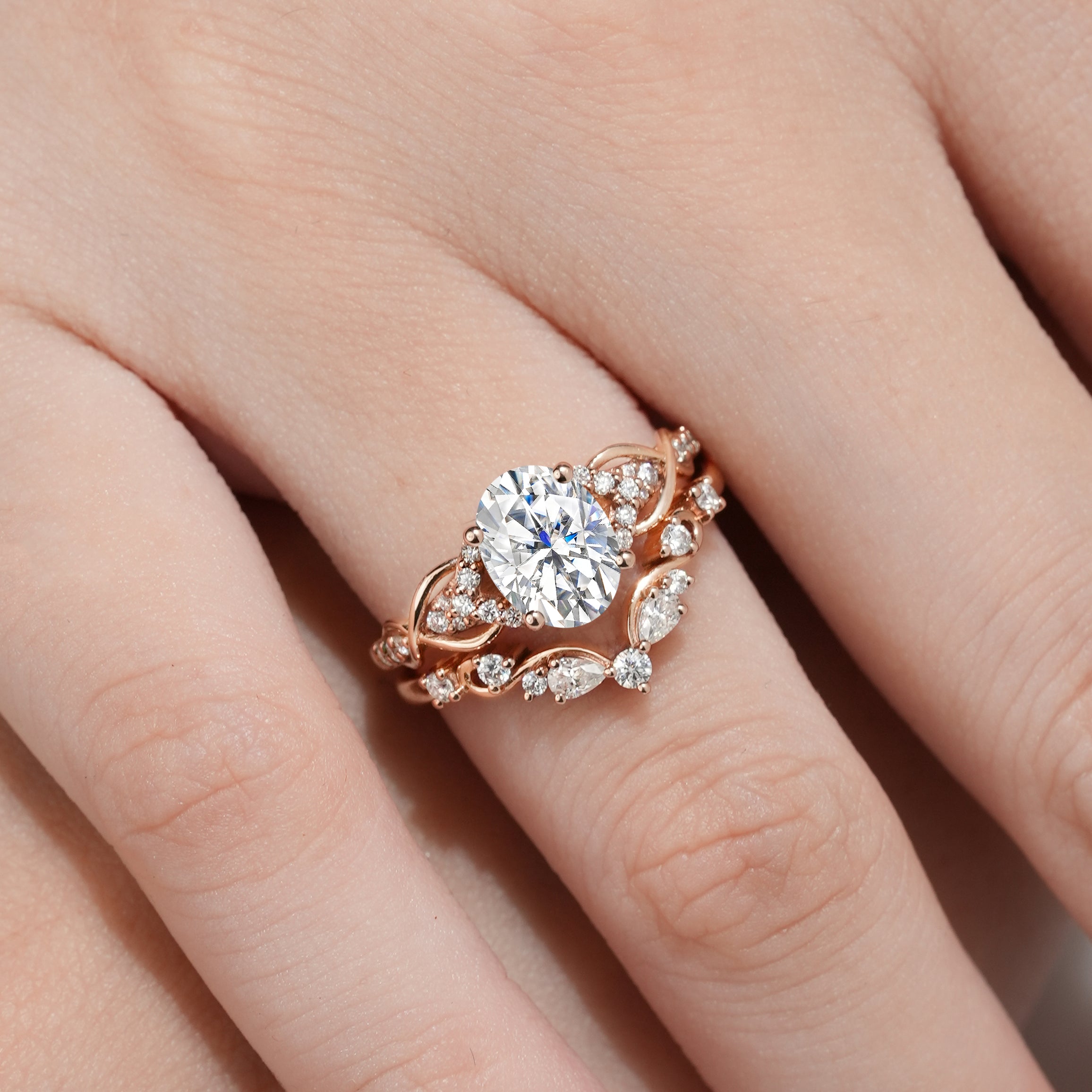 Rose gold moissanite engagement ring with nature-inspired leaf detailing