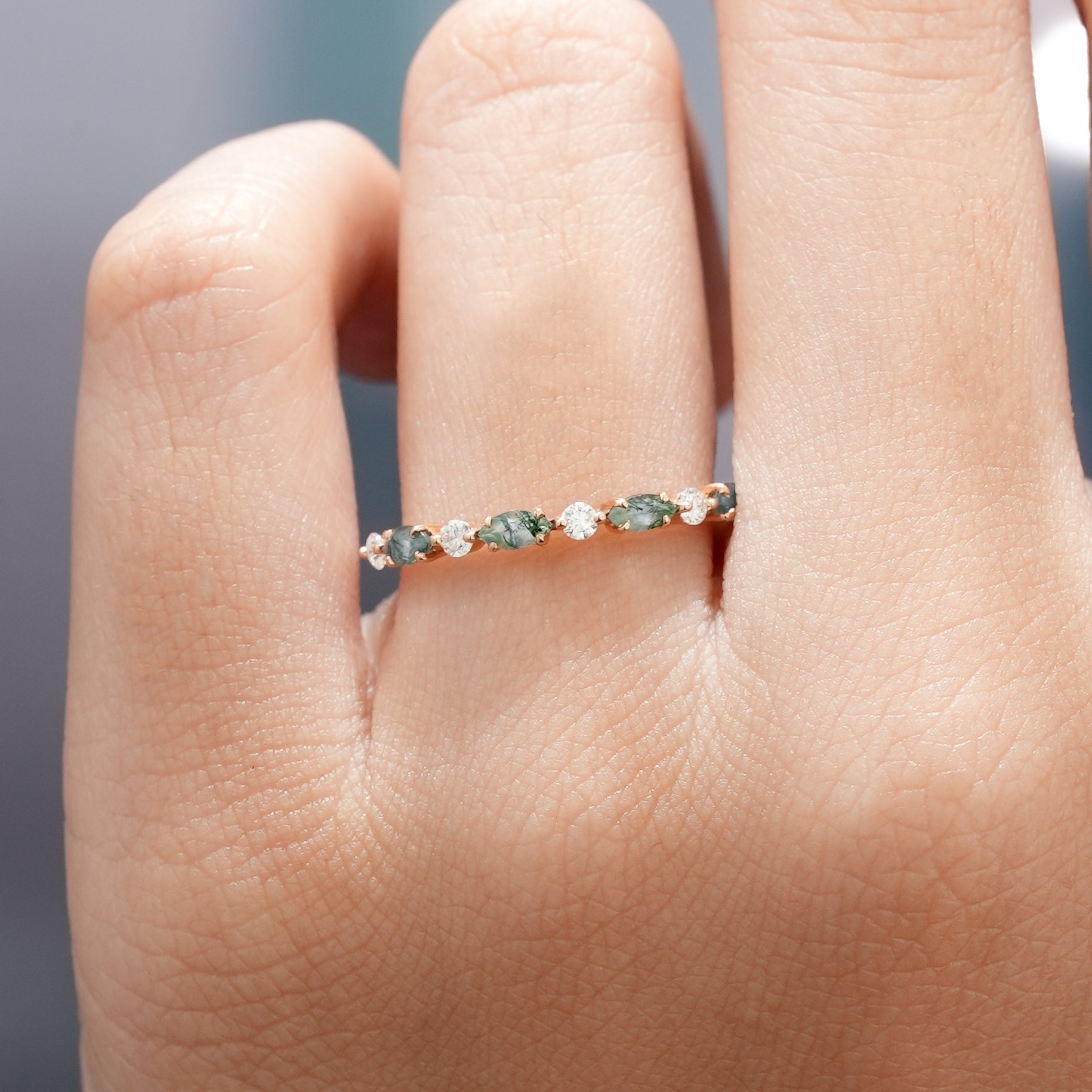 Marquise cut moss agate and moissanite band on finger
