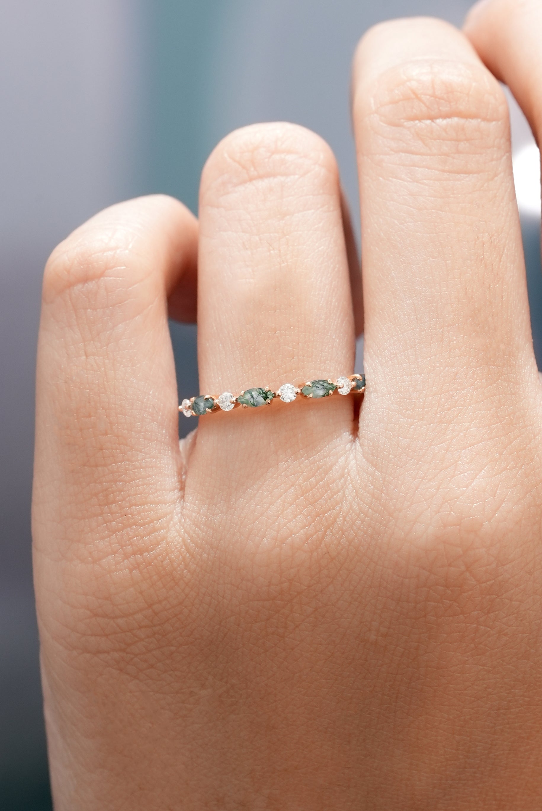 Marquise cut moss agate and moissanite band on finger