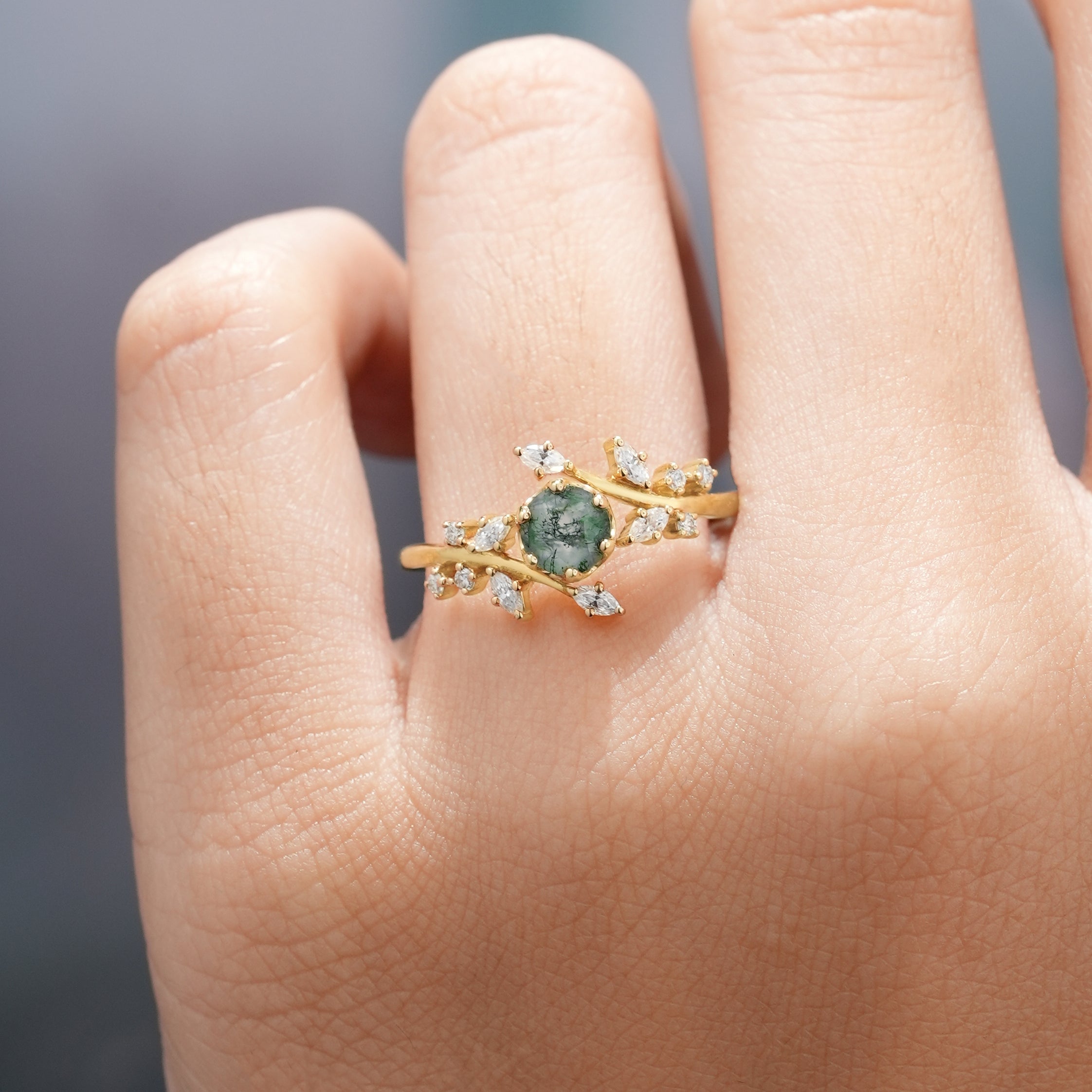 Moss Agate Engagement Ring in Hand with leaf detail