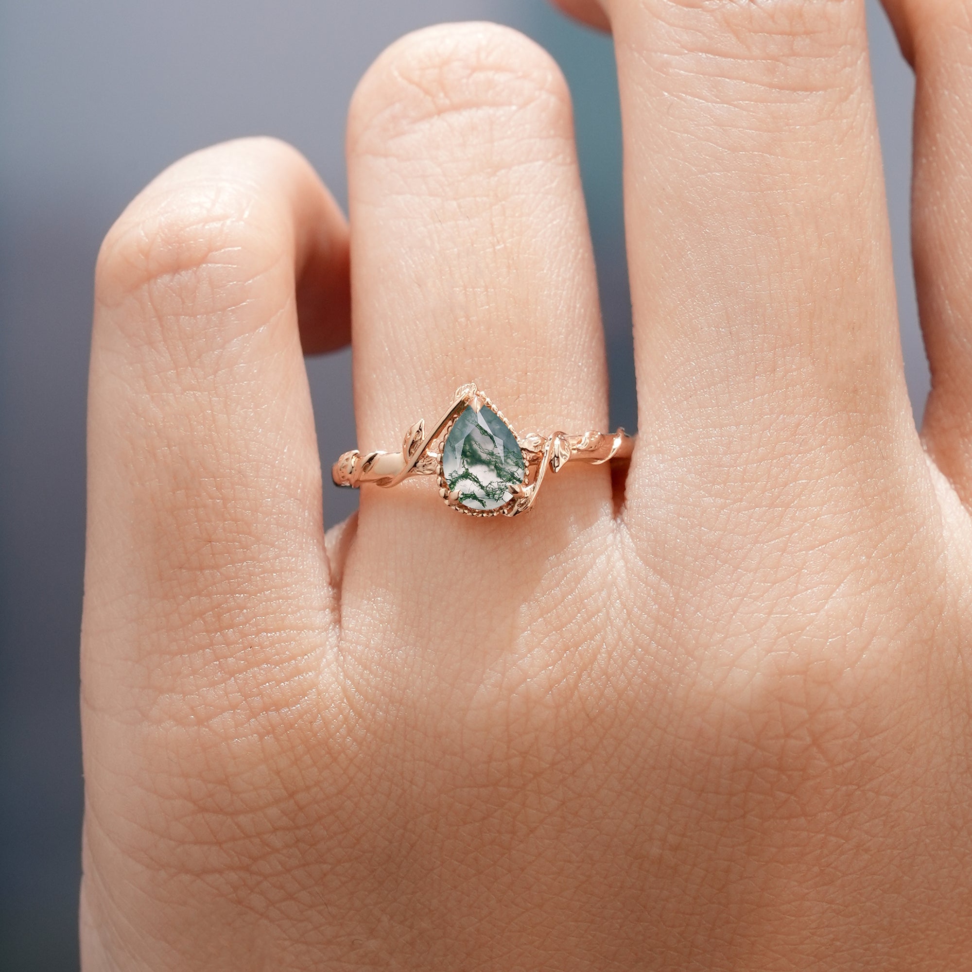 Moss agate engagement ring with leaf detailing, nature inspired design