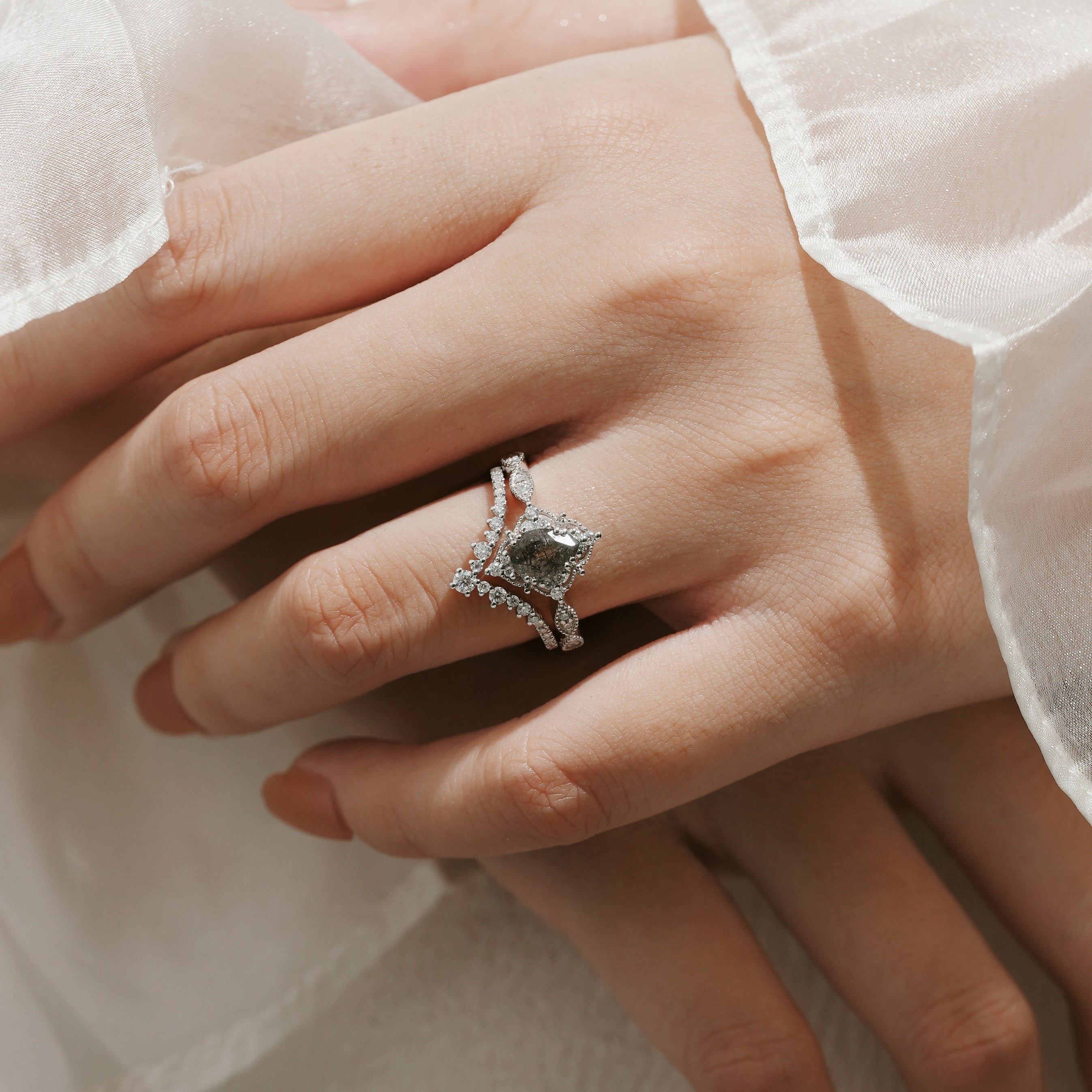 Black rutilated quartz engagement ring set on a woman's hand