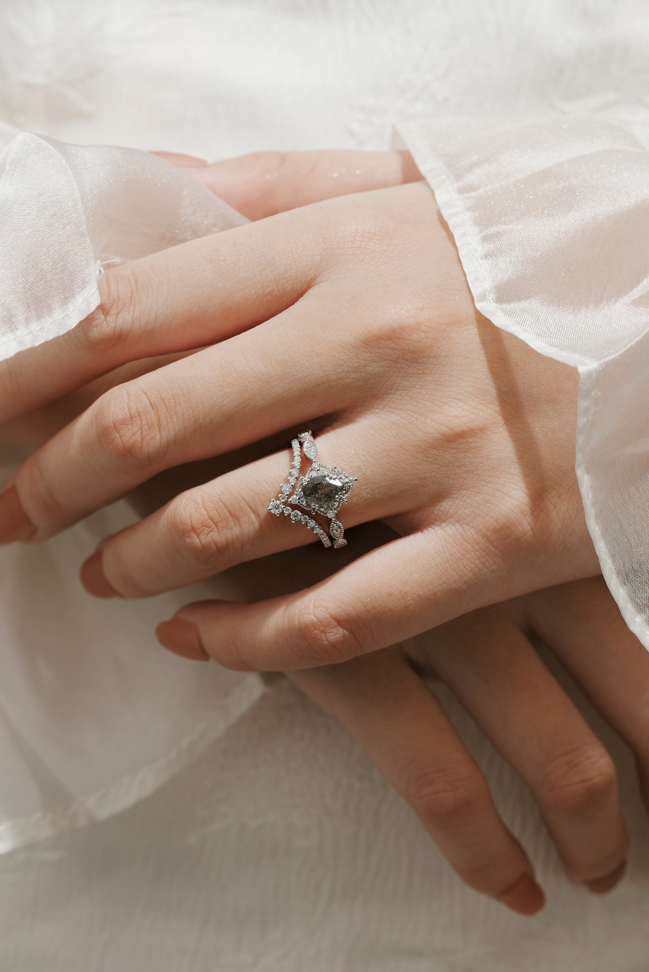 Black rutilated quartz engagement ring set on a woman's hand