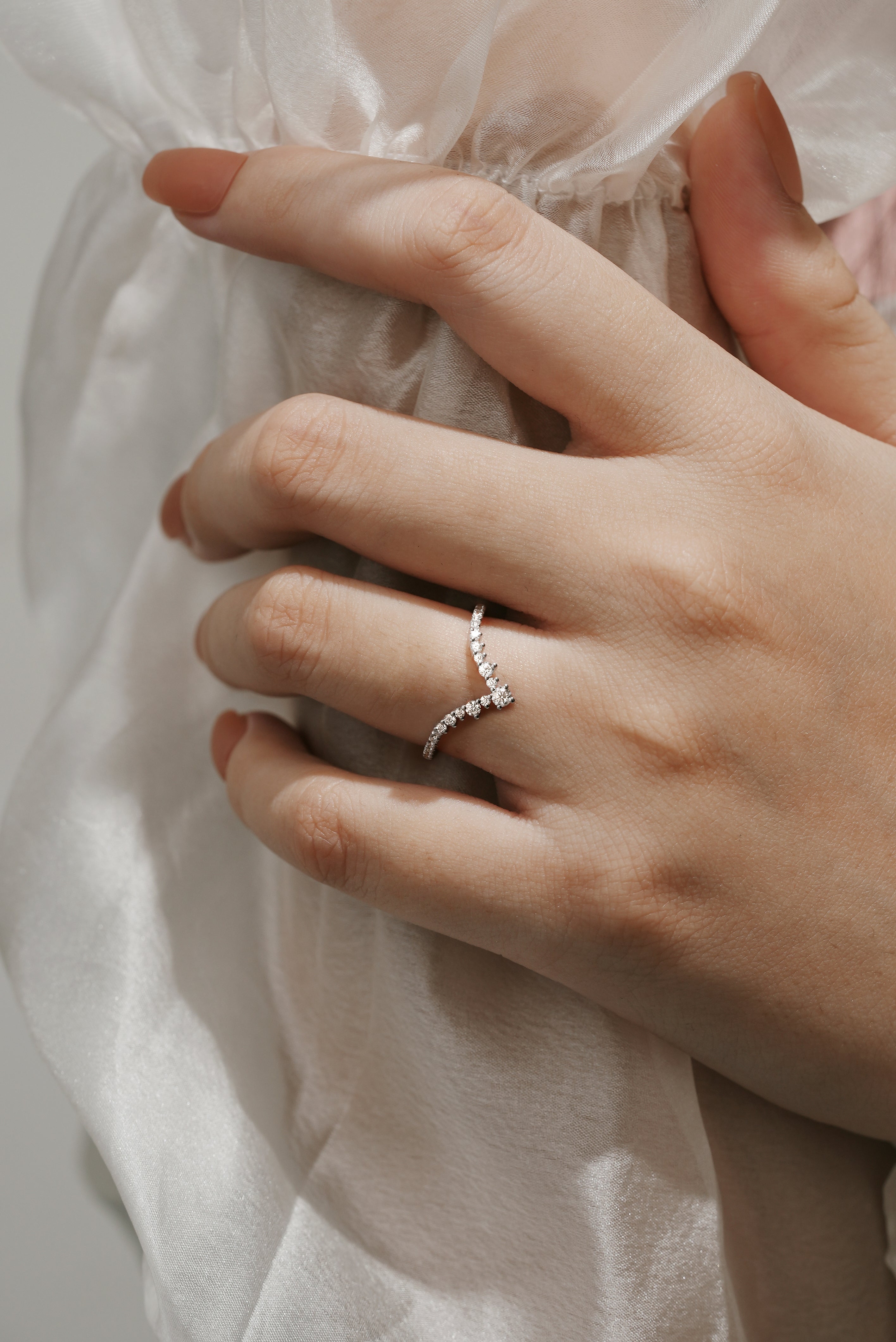 Moissanite V-Shaped Wedding Band on hand