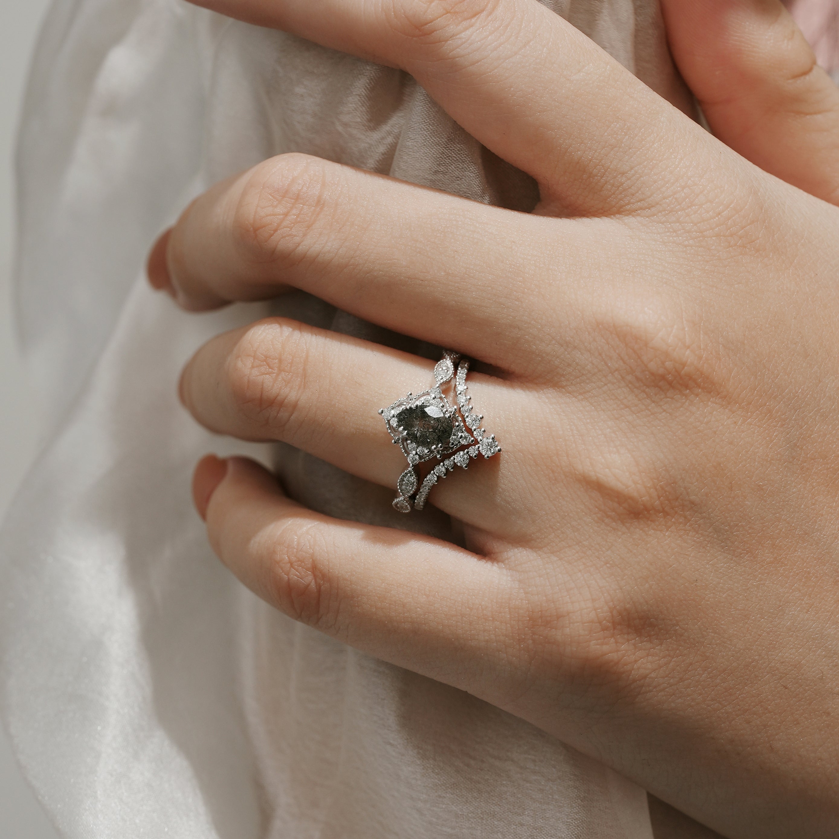 Woman's hand wearing black rutilated quartz engagement ring set
