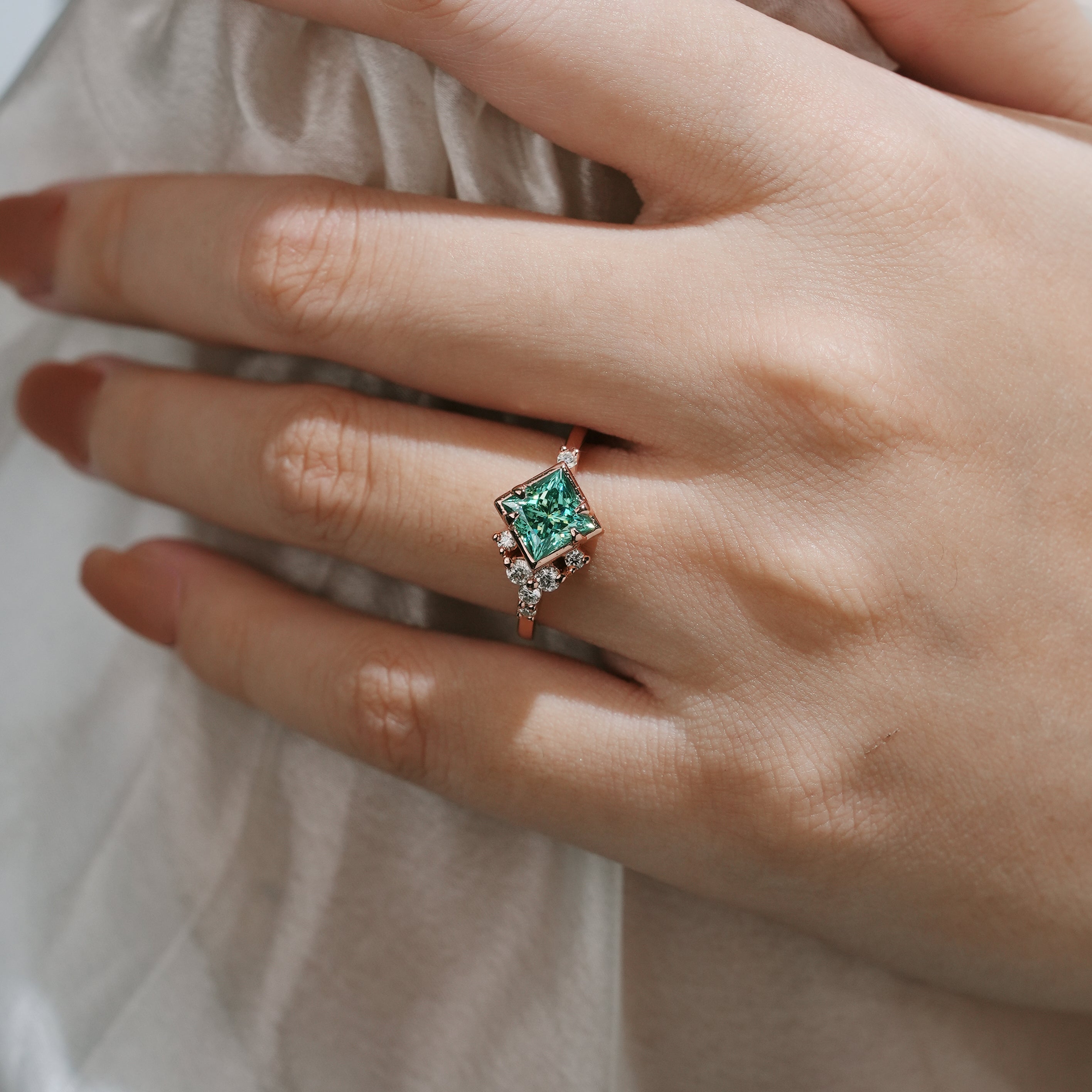 Rose gold engagement ring with green moissanite, elegant design