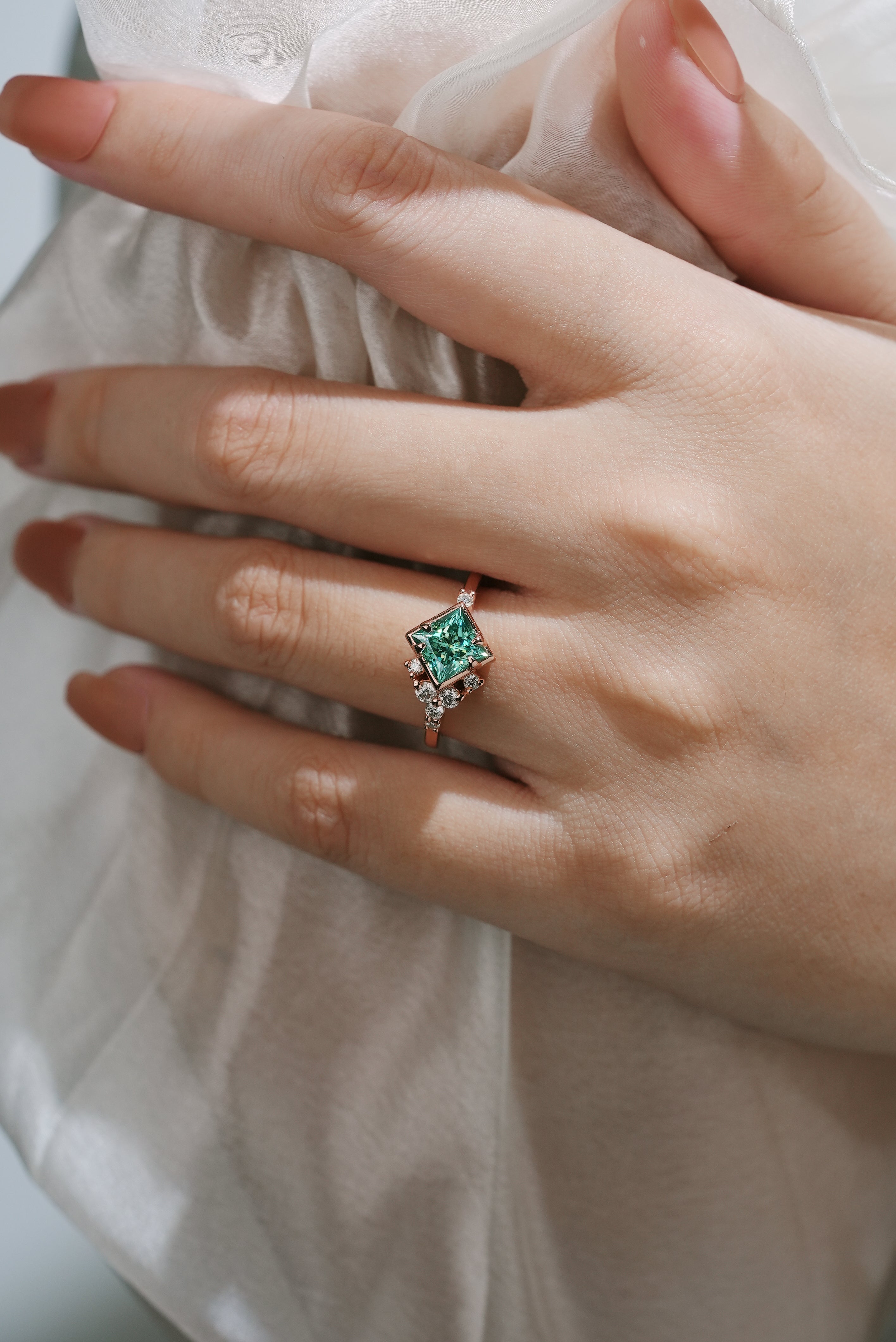 Rose gold engagement ring with green moissanite, elegant design