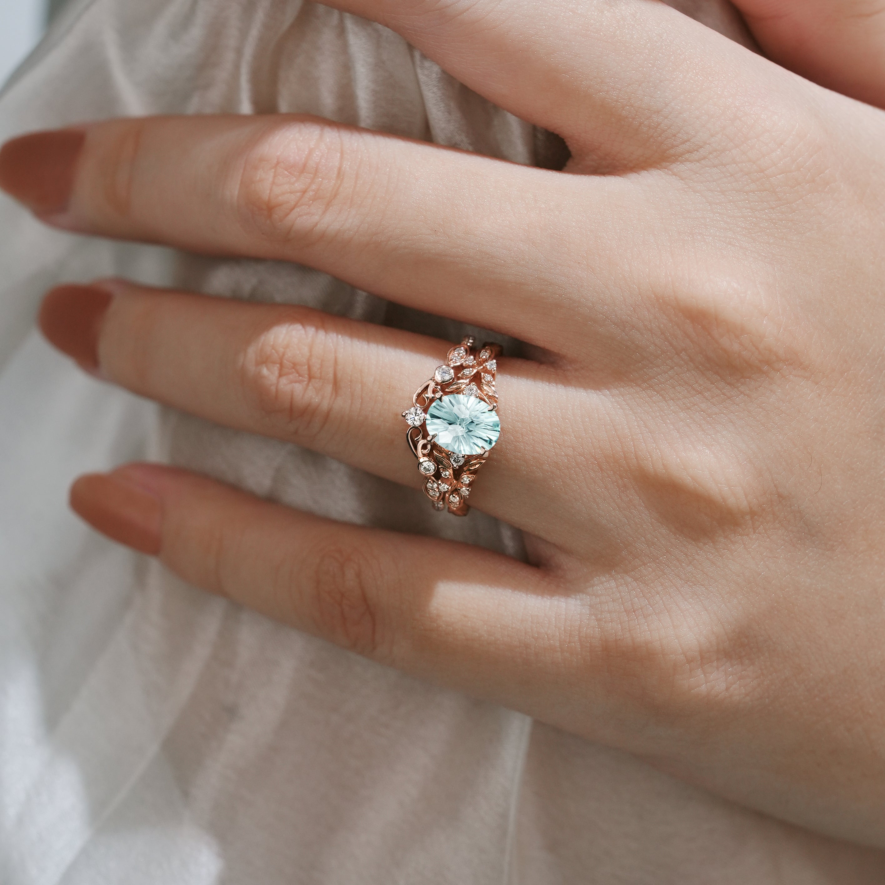 Aquamarine leaf engagement ring on a hand