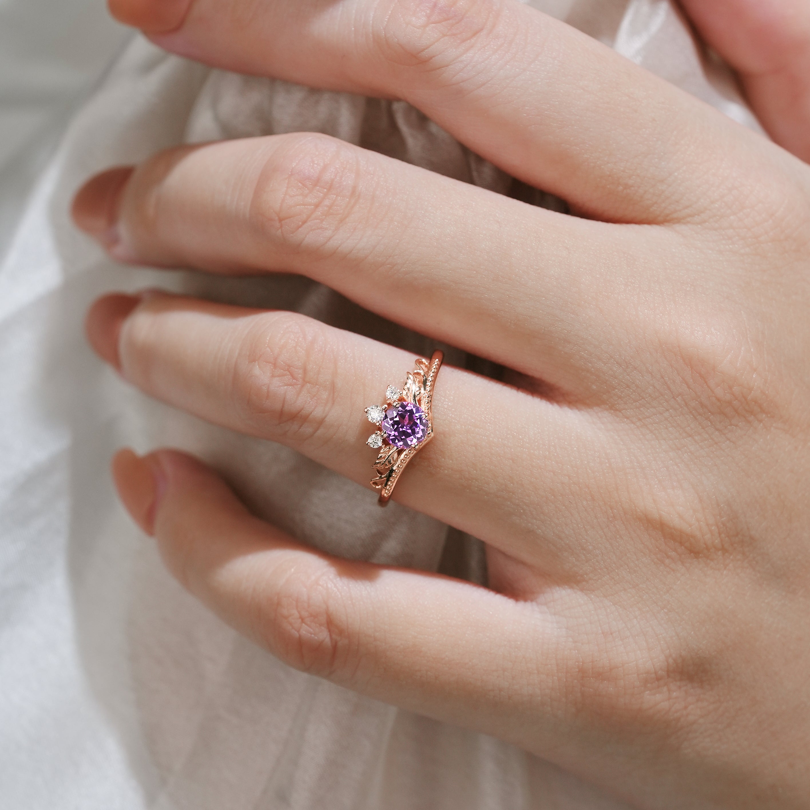 Woman wearing purple sapphire leaf engagement ring. Lahela Jewelry