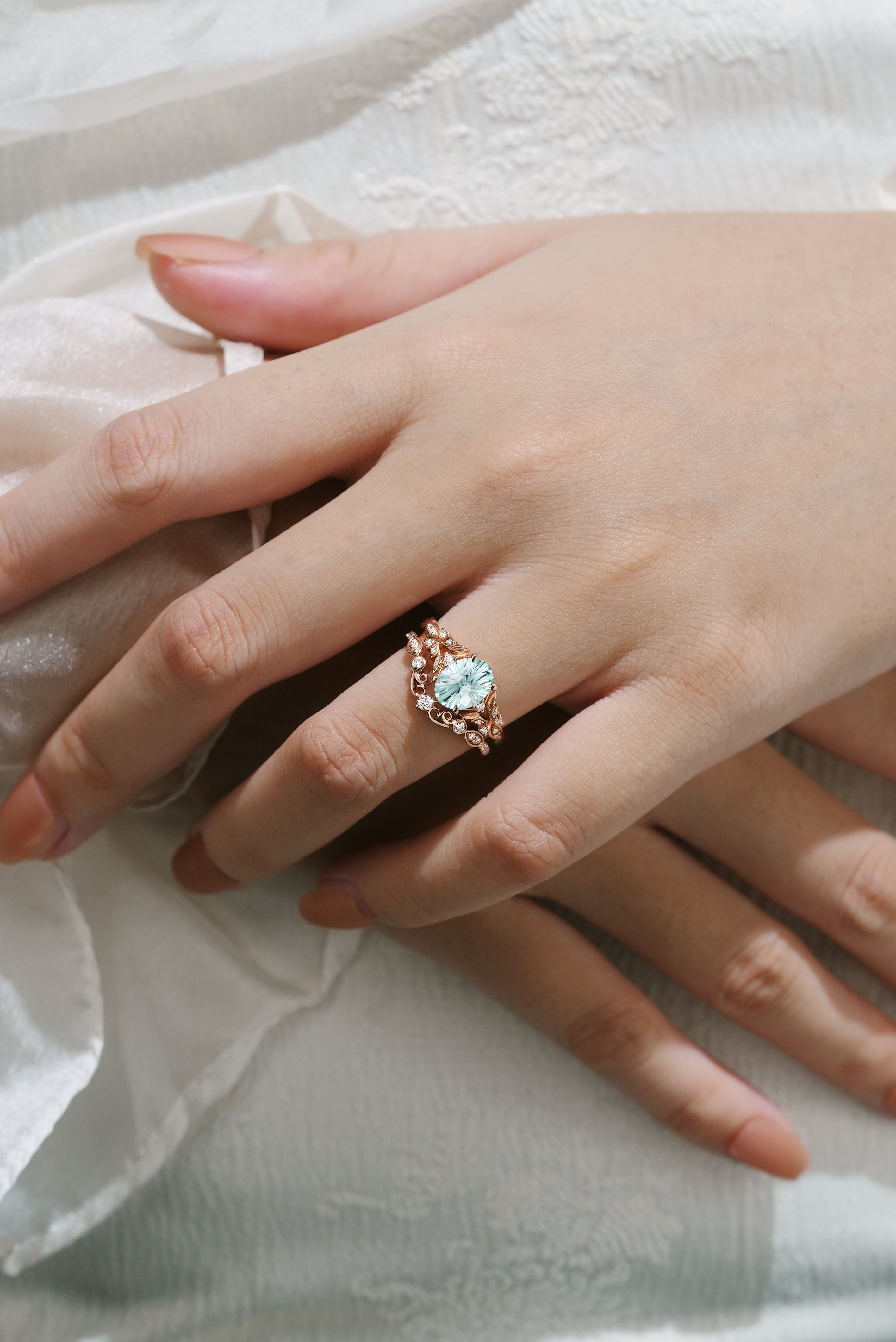 Aquamarine leaf engagement ring set on hand, rose gold