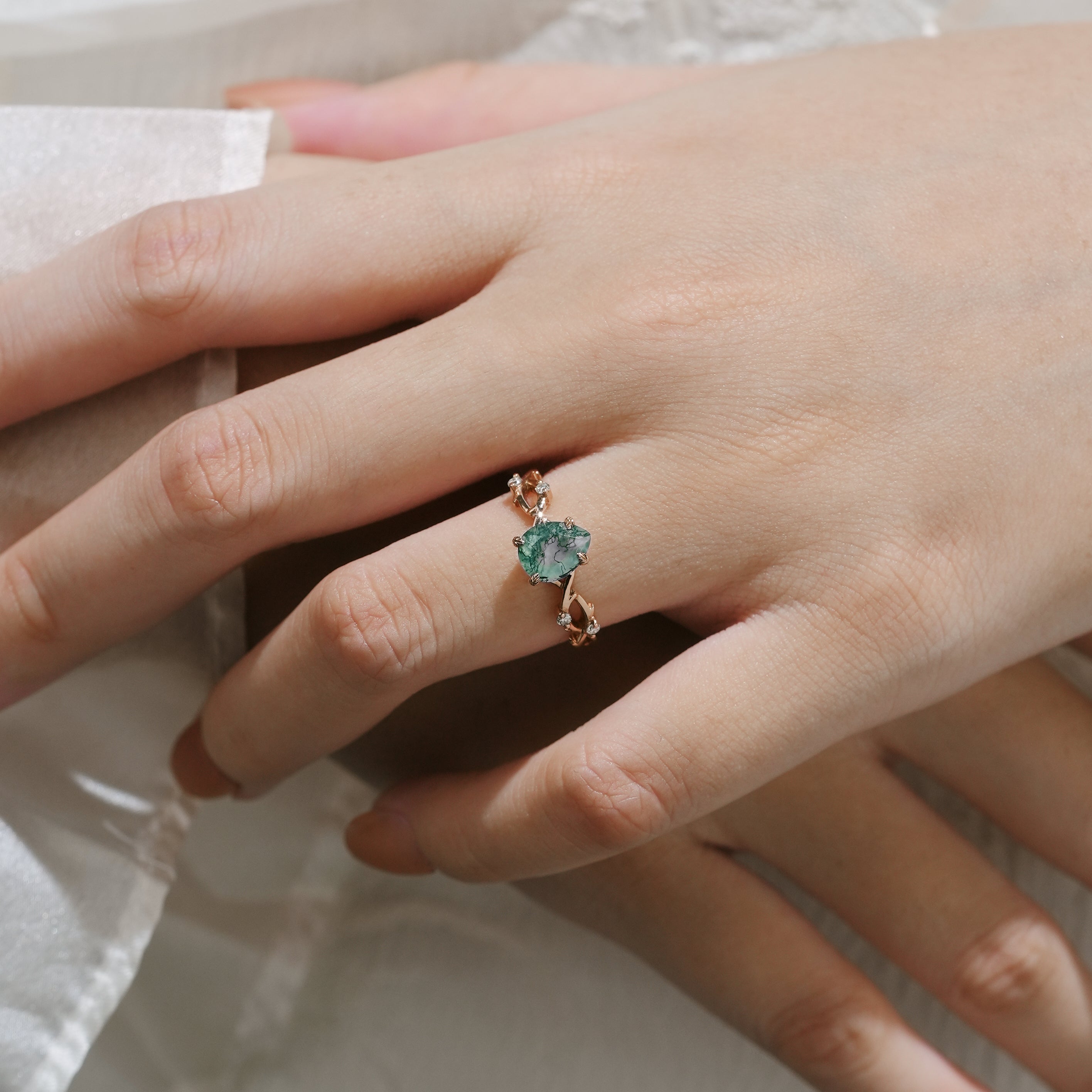 Woman wearing moss agate vine leaf ring, Lahela Jewelry