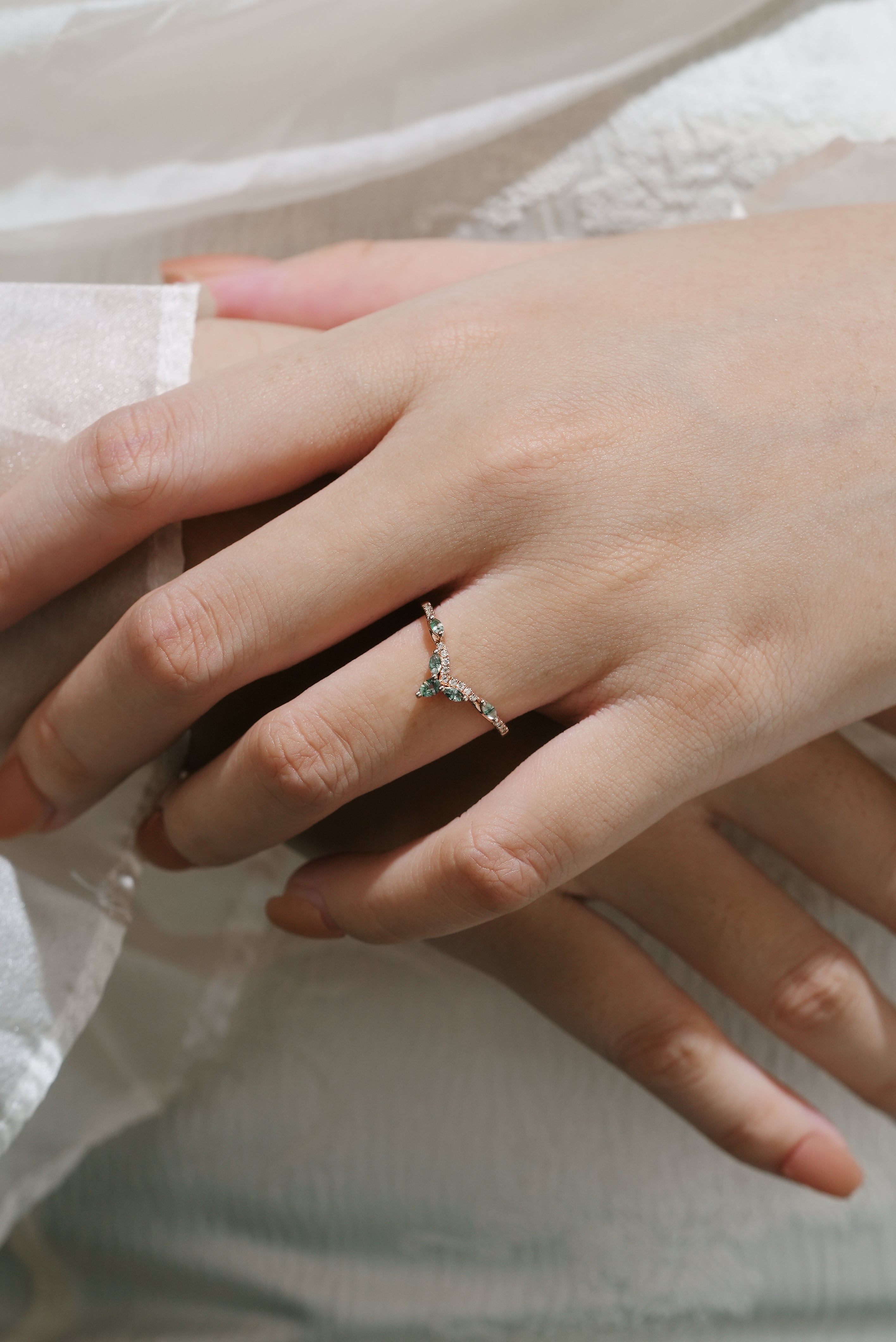 Rose gold moss agate and moissanite wedding band, leaf design, bridal ring on hand. Shop now!