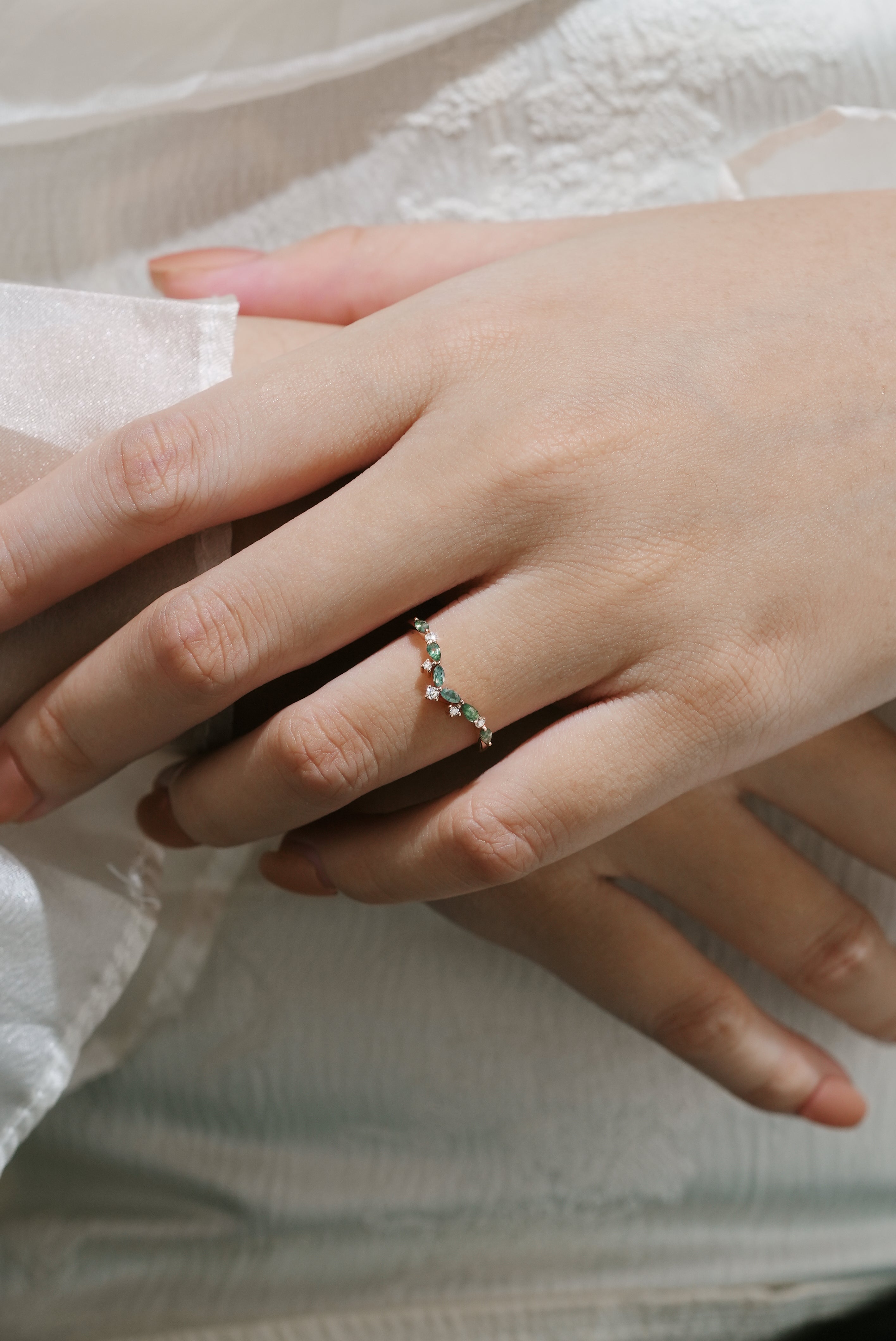 Hand wearing moss agate curved wedding band