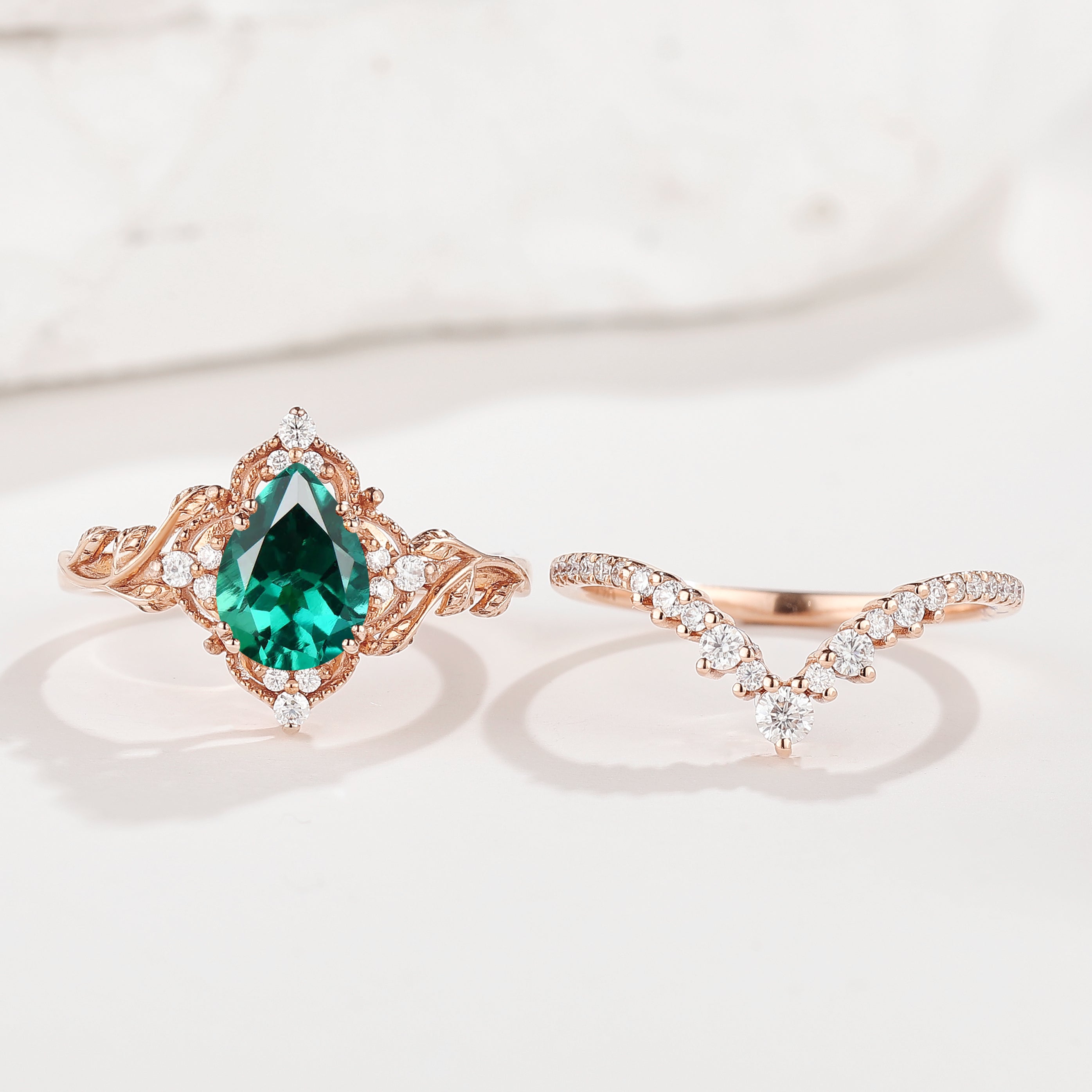 Rose gold emerald engagement ring set with moissanite accents