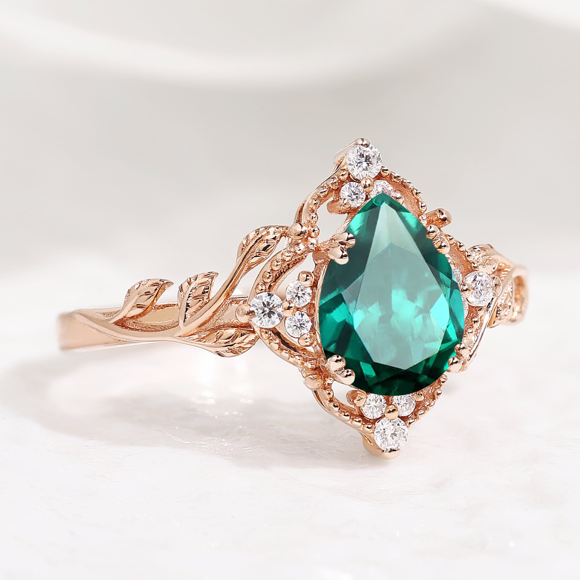 Nature-inspired pear cut lab emerald engagement ring