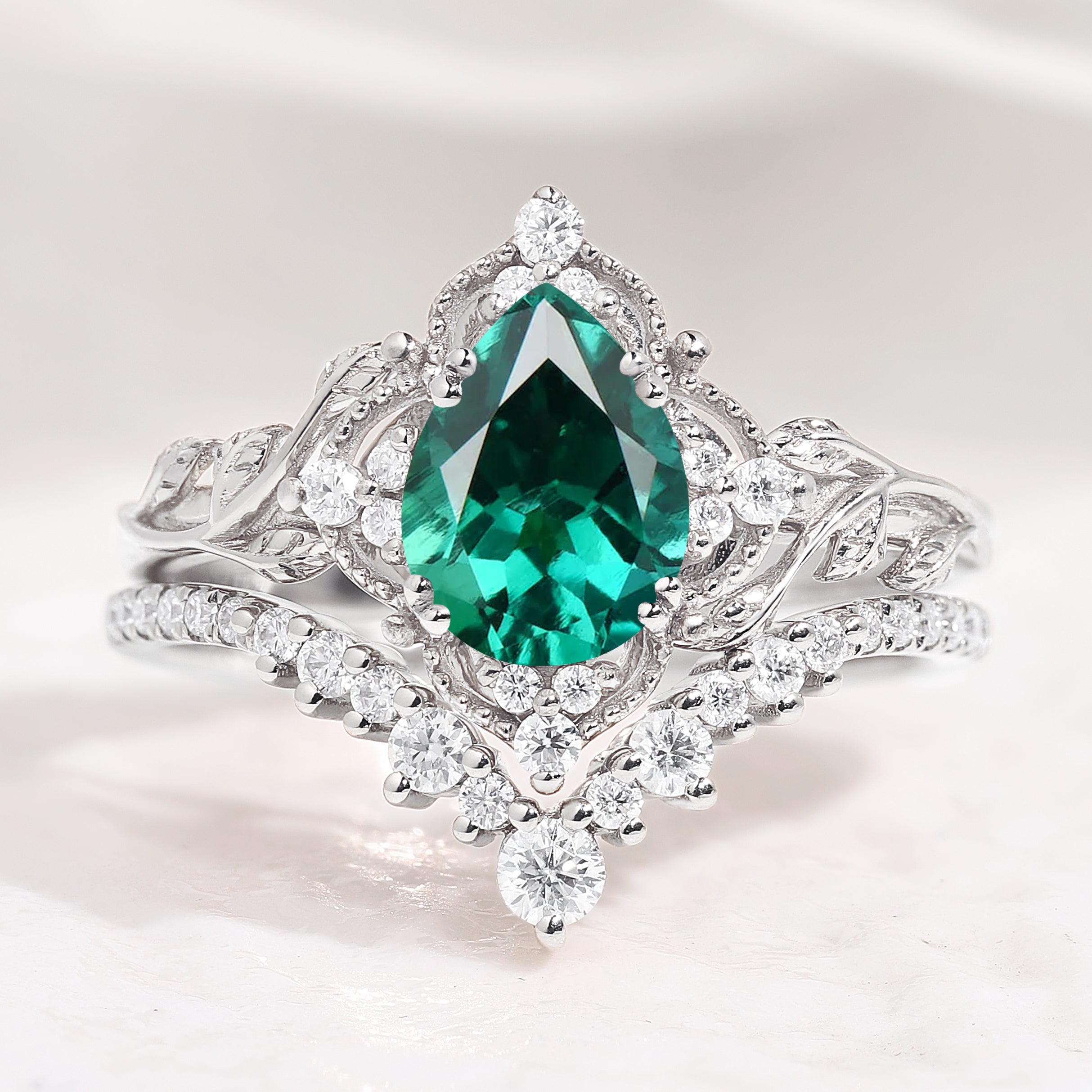 Lab emerald leaf engagement ring set with moissanite accents