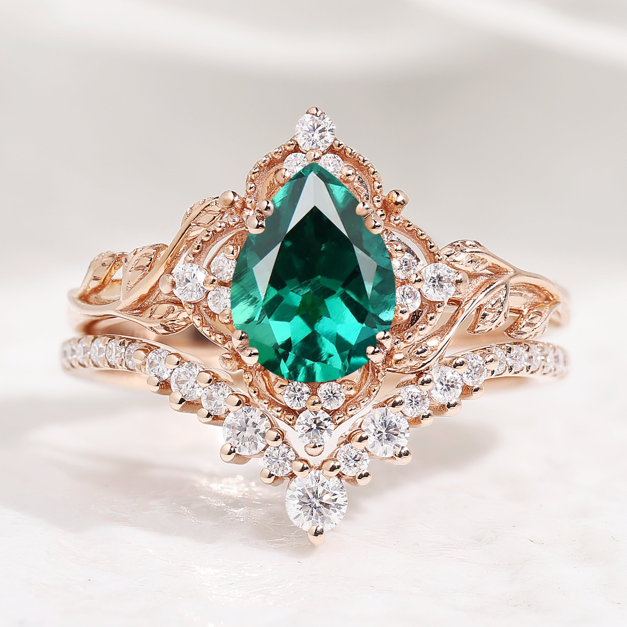 Nature-inspired pear cut lab emerald engagement ring set