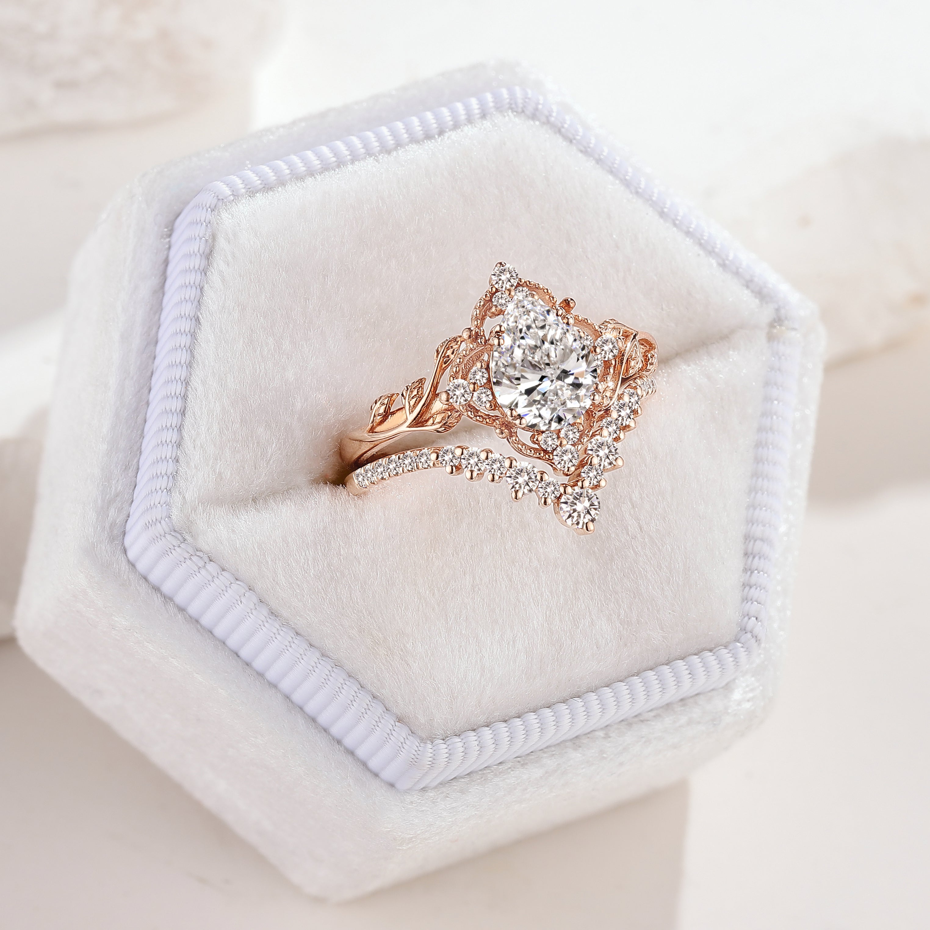 Rose gold pear cut leaf engagement ring set in white box
