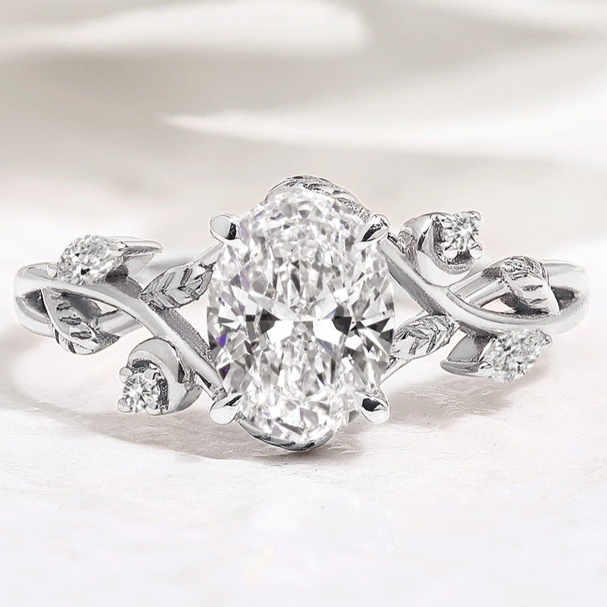 Nature-inspired oval diamond engagement ring with leaf design