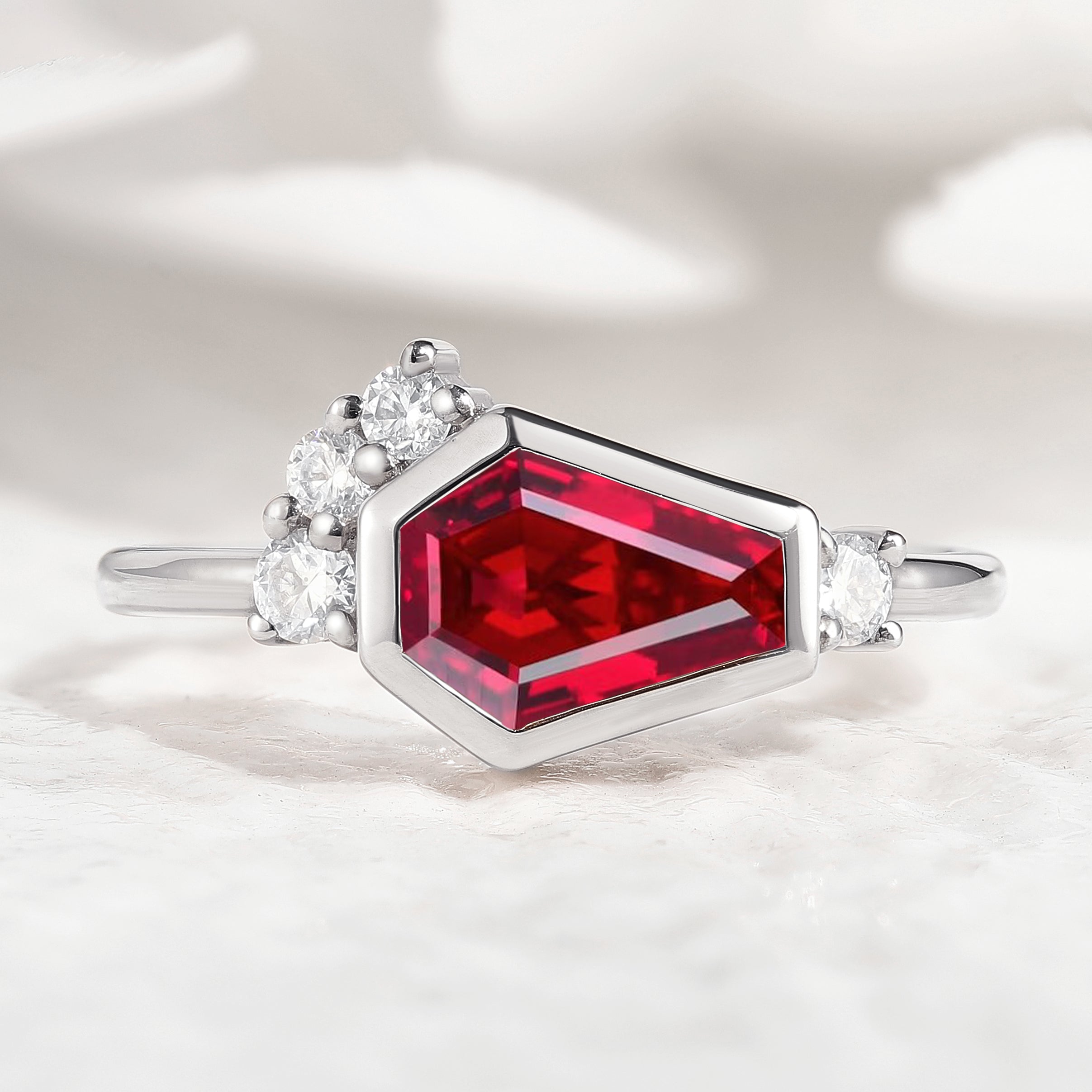 Coffin cut ruby engagement ring with side accents