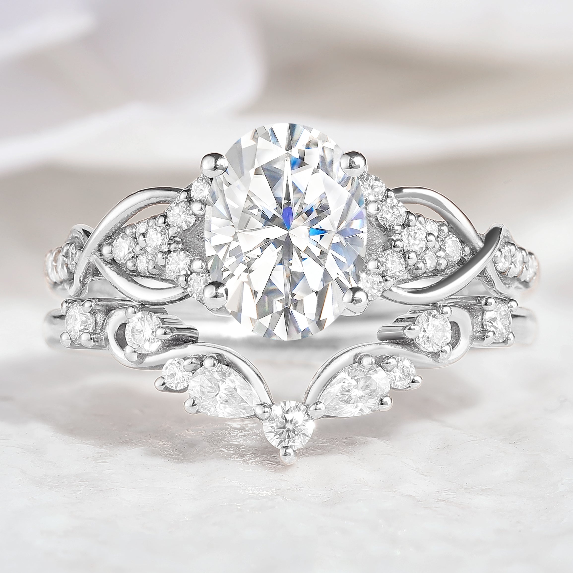 Oval moissanite engagement ring and curved band set, nature-inspired design