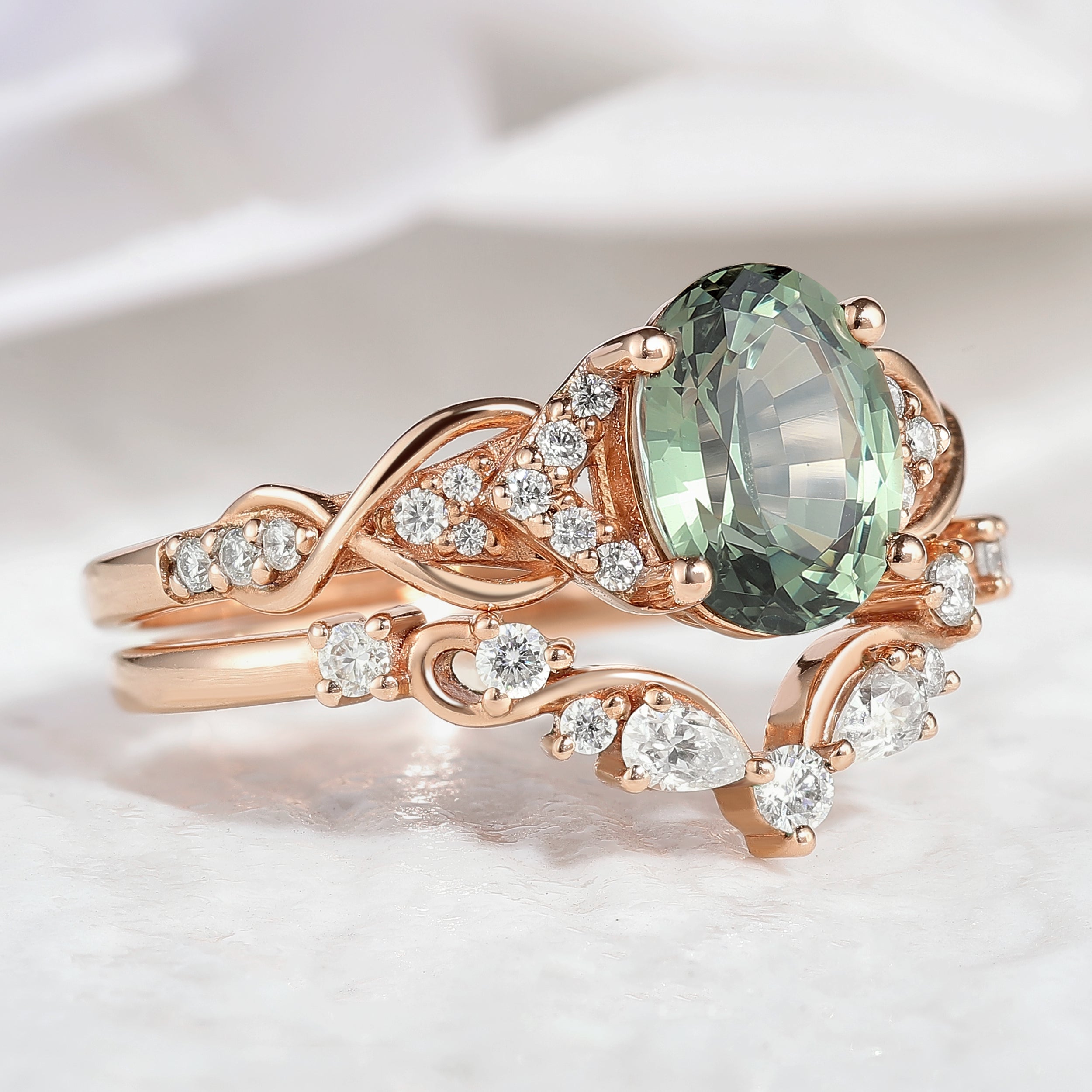 Rose gold engagement ring set with oval green sapphire and moissanite accents