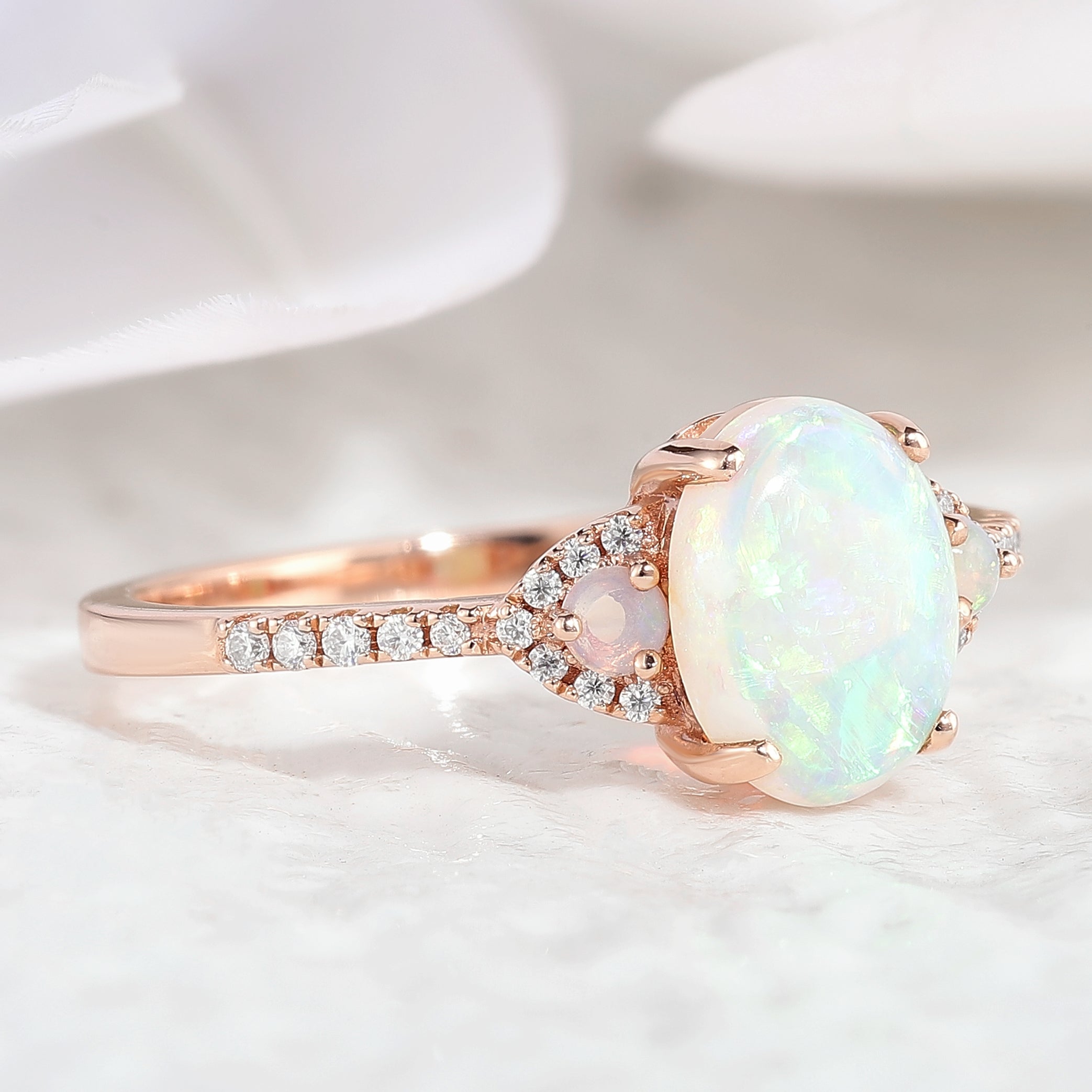 Rose gold opal engagement ring with oval cut opal gemstone