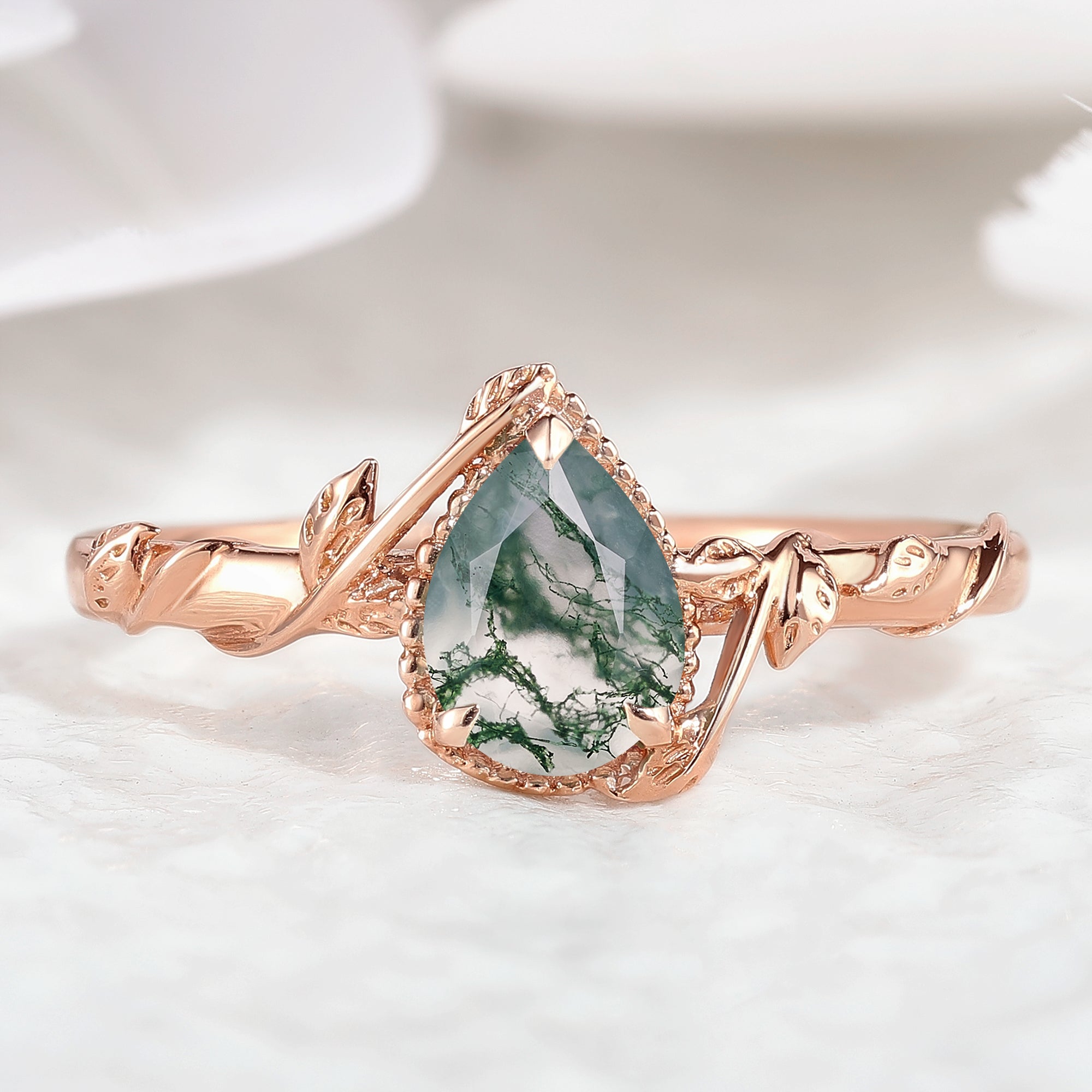 Pear cut moss agate engagement ring with leaf design