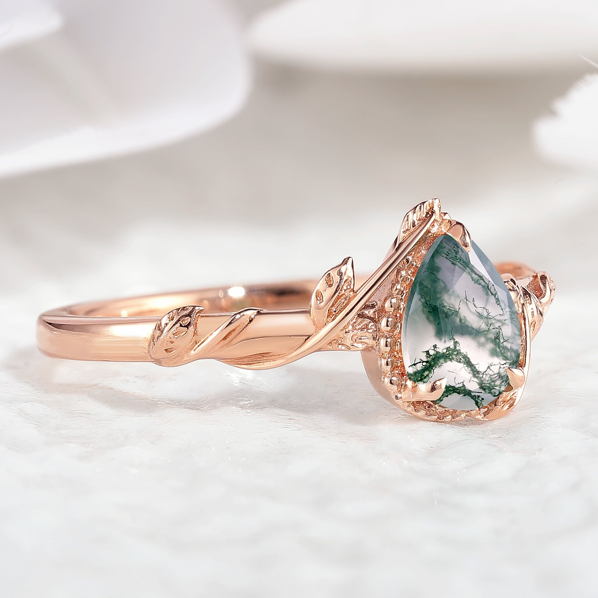 Rose gold pear cut moss agate engagement ring with leaf details