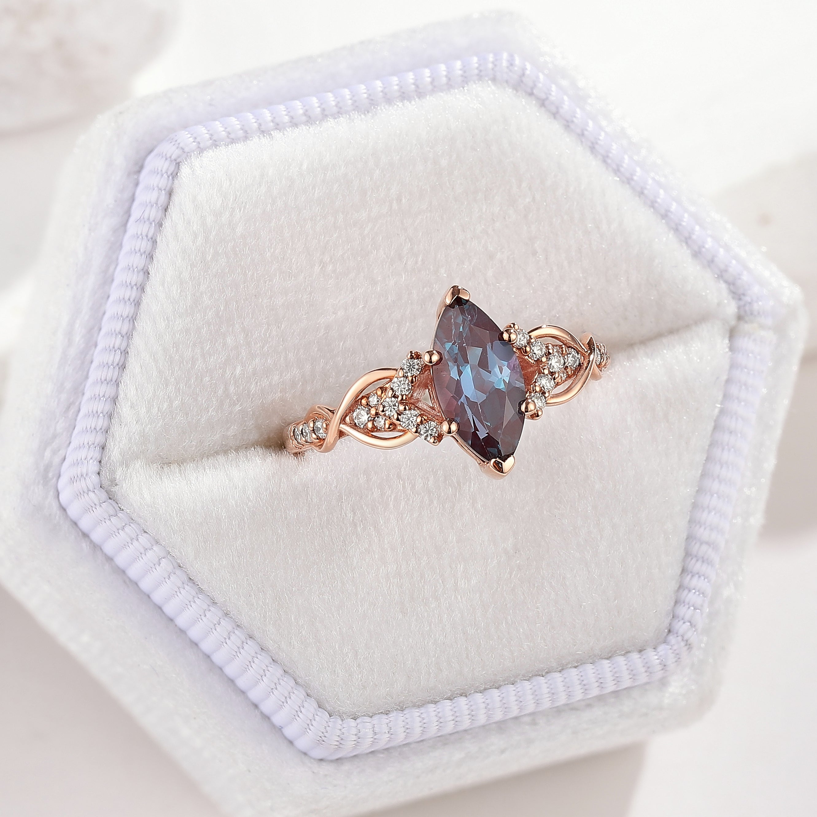Rose gold marquise cut alexandrite engagement ring with moissanite accents