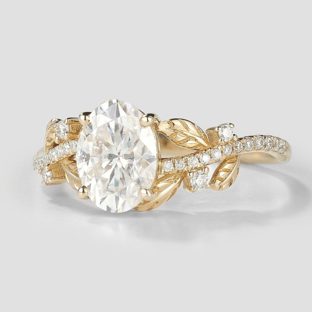 Oval cut moissanite engagement ring with leaf design