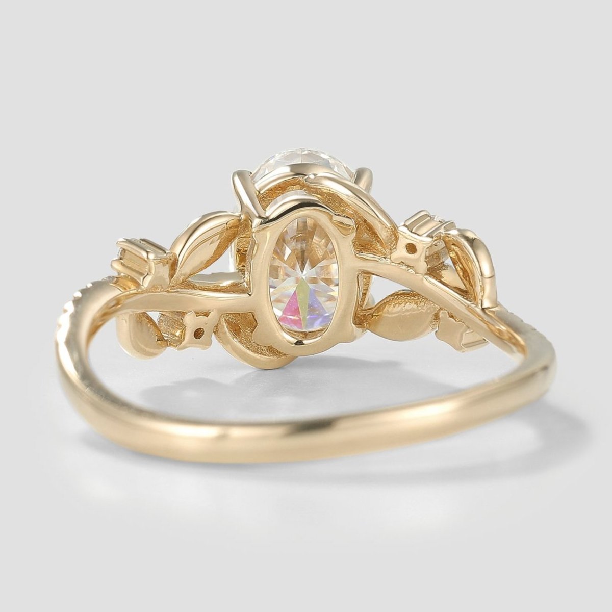 Close-up view of nature-inspired leaf ring with moissanite center
