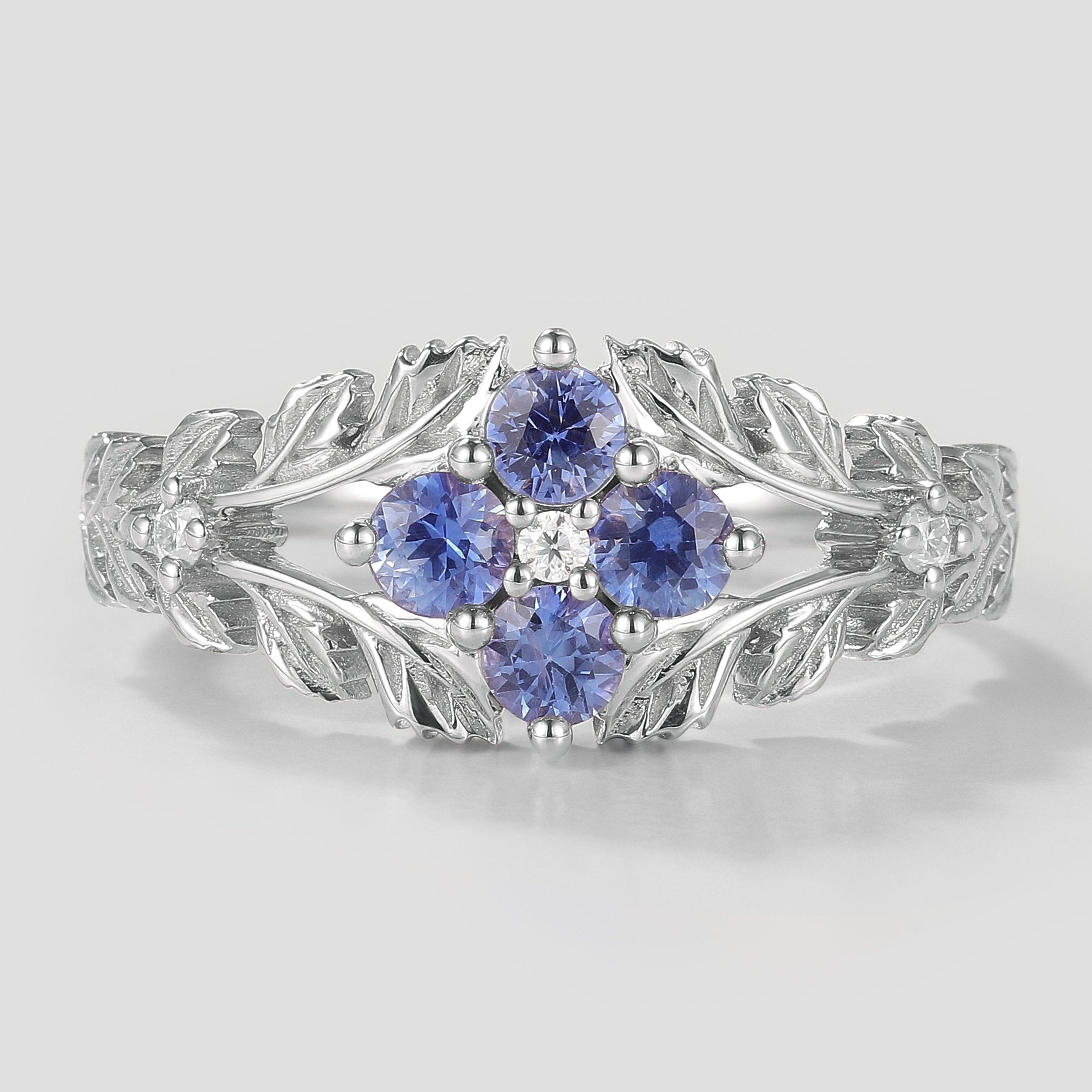 Cornflower sapphire engagement ring with leaf design