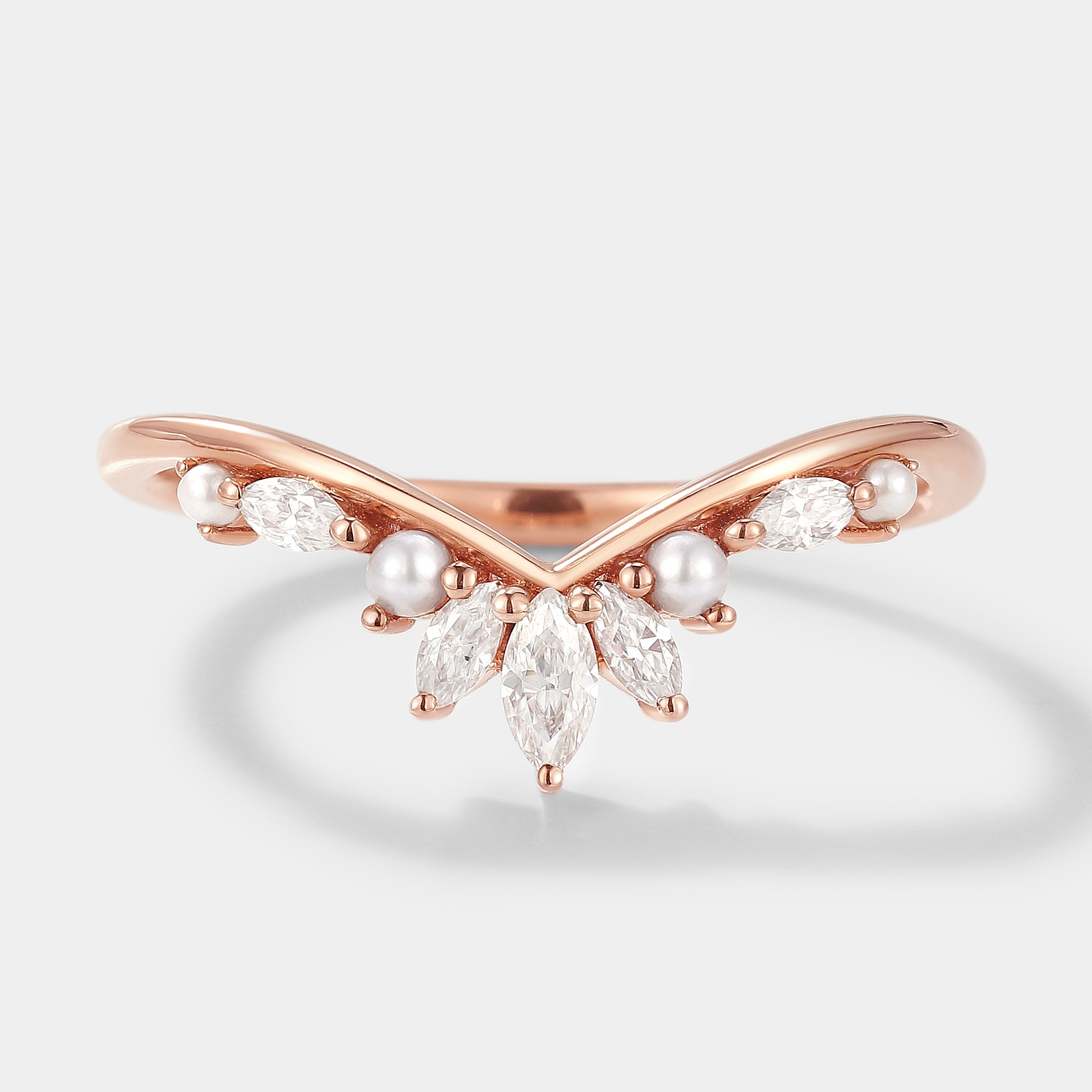 Curved rose gold wedding band with moissanite and pearl accents