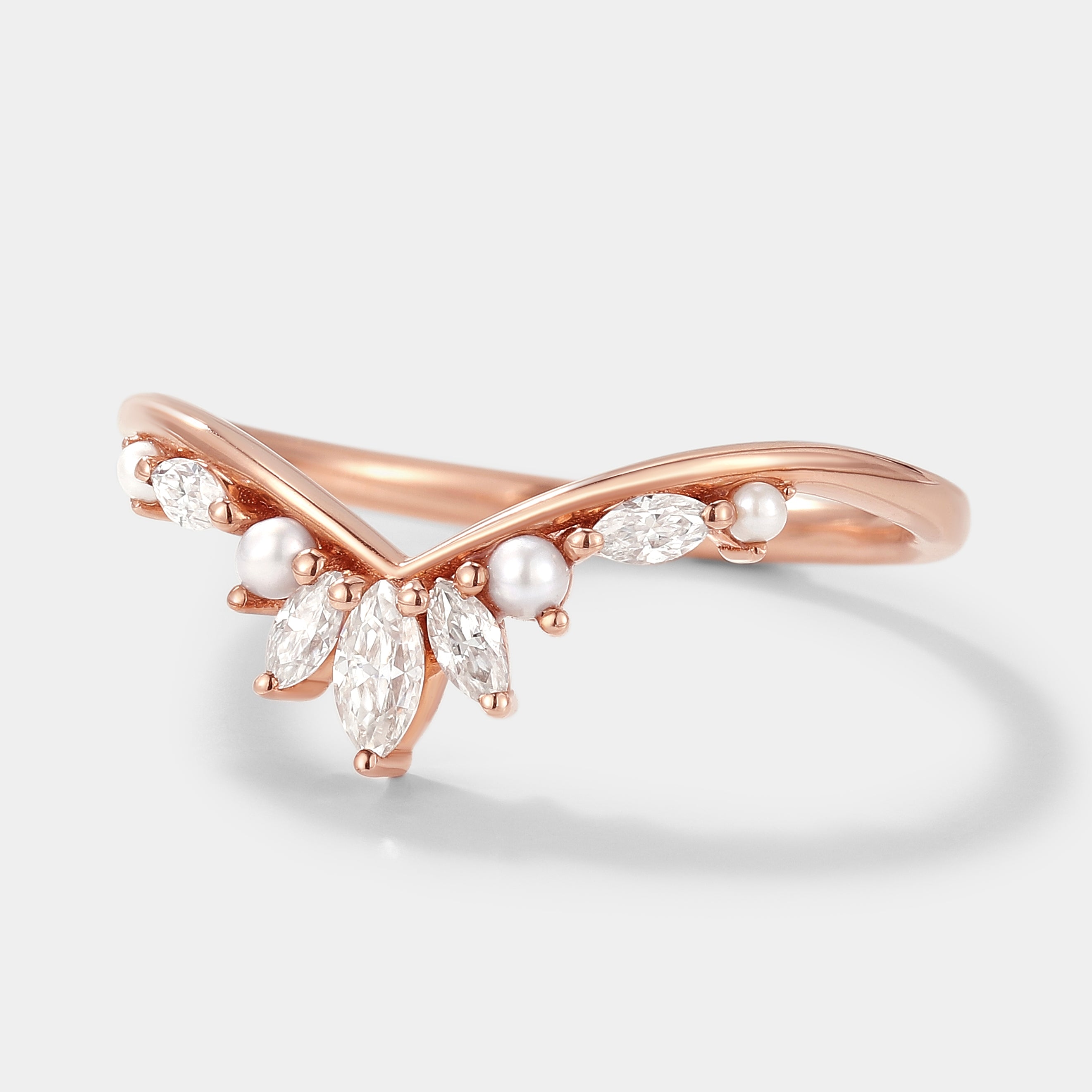 Rose gold curved wedding band with moissanite and pearl accents