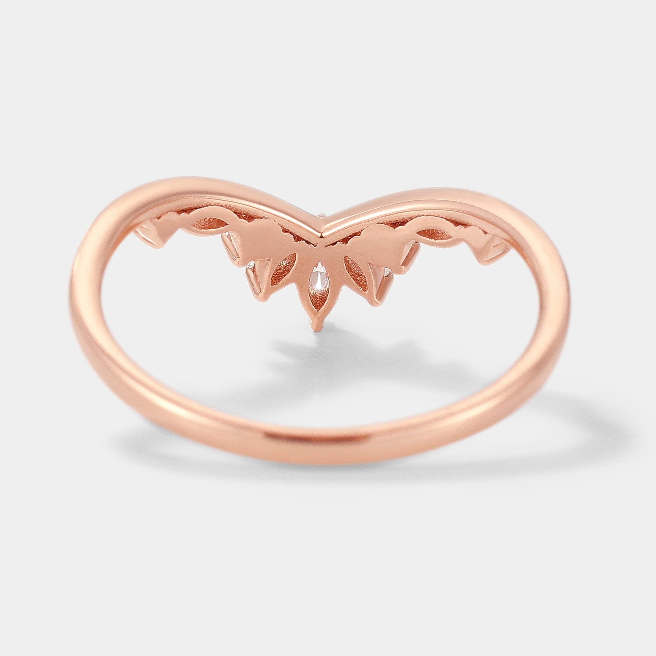 Rose gold curved wedding band with moissanite accents