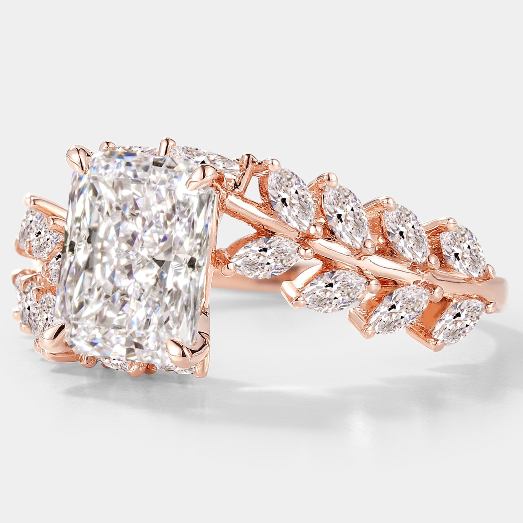 Rose gold emerald cut diamond ring with leaf detail
