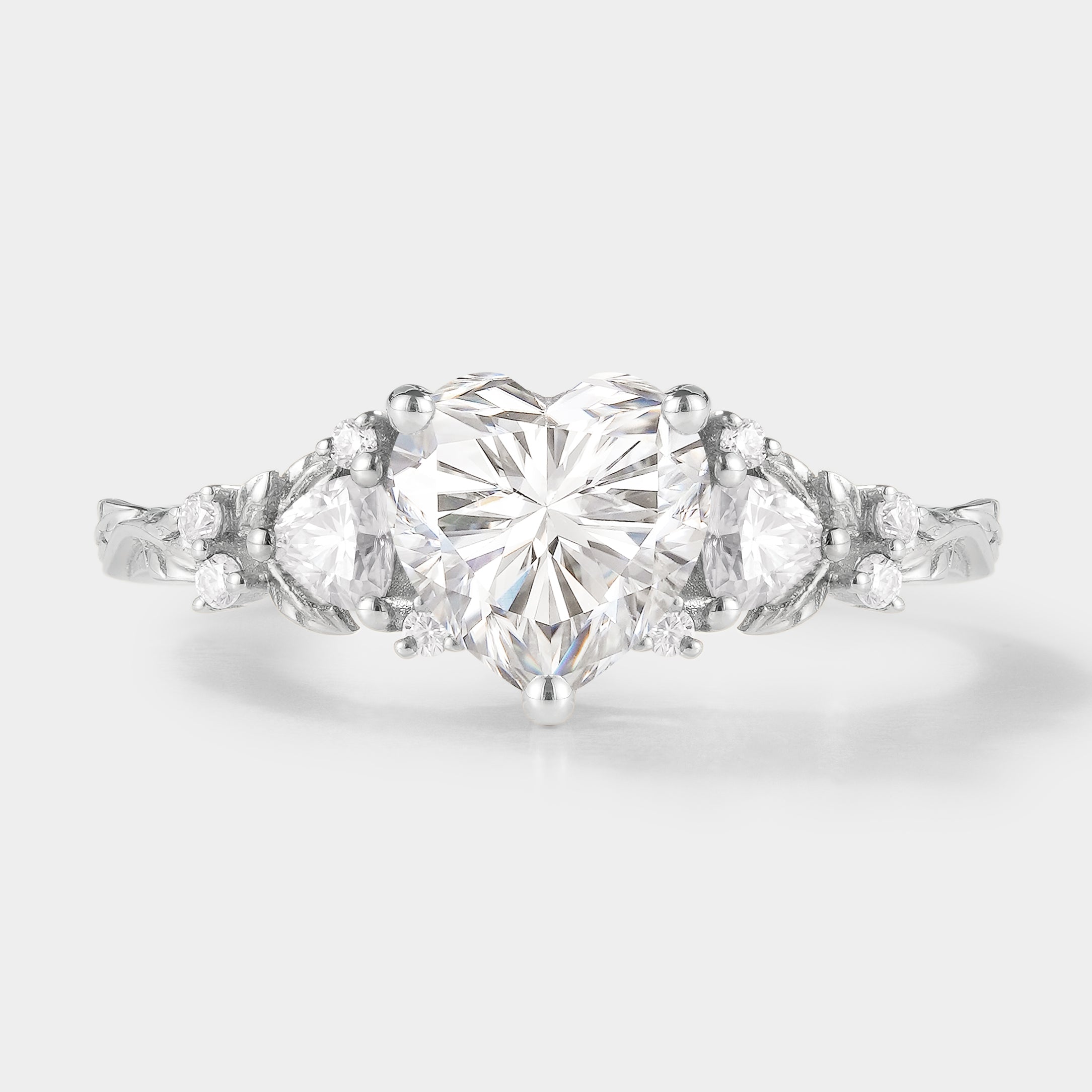 Heart-cut moissanite ring with leaf-design band