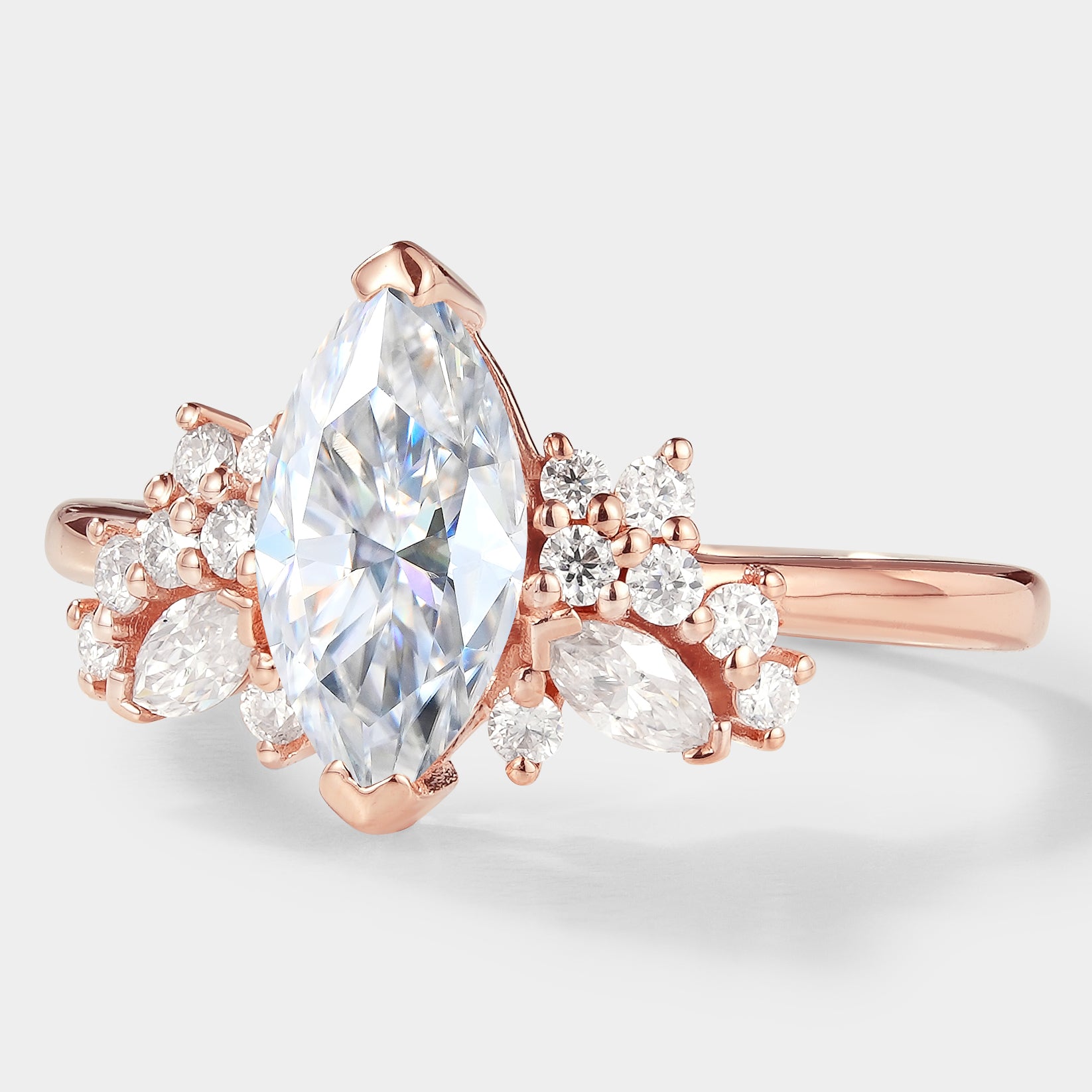 Marquise cut moissanite cluster engagement ring in rose gold