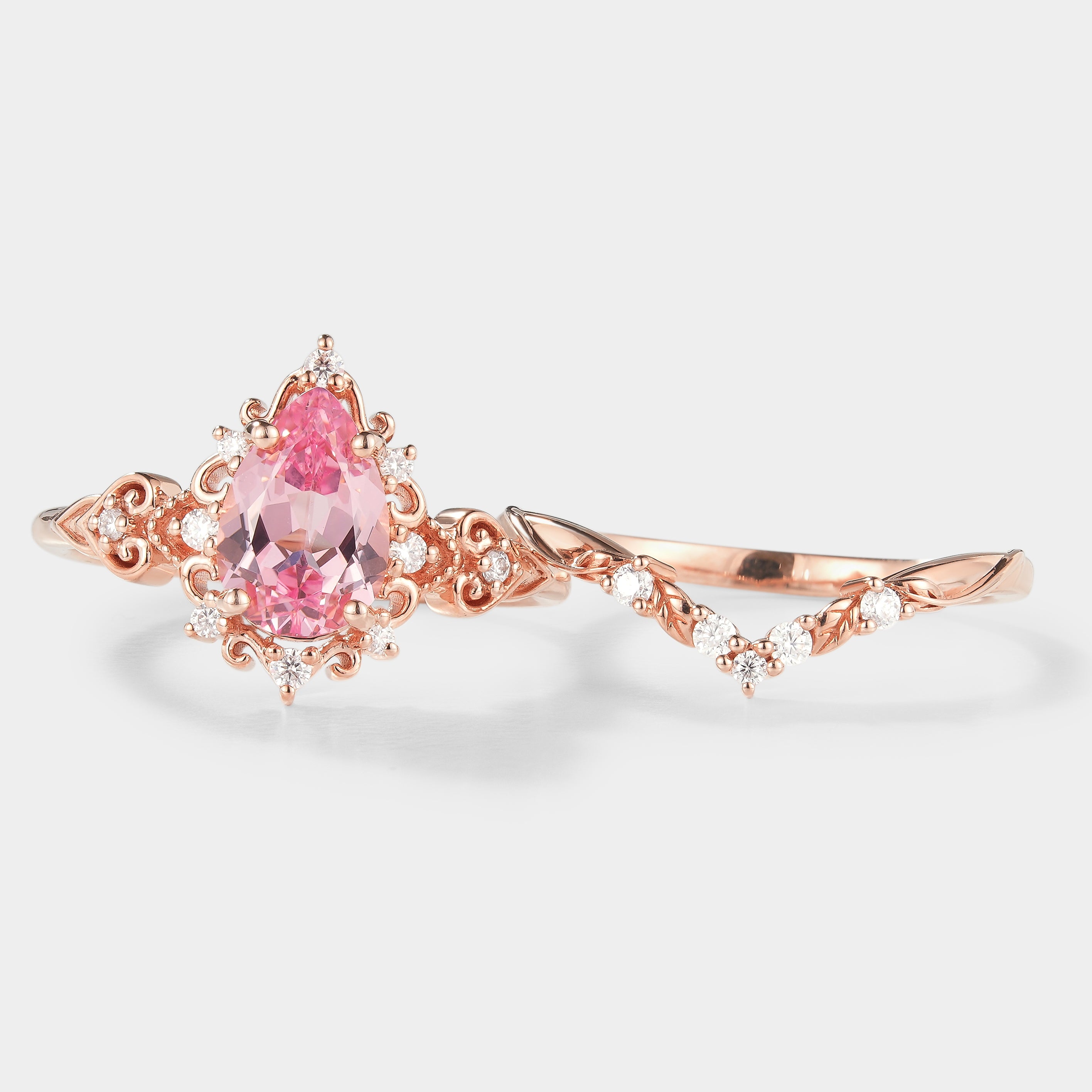 Rose gold Padparadscha sapphire engagement ring set with leaf wedding band