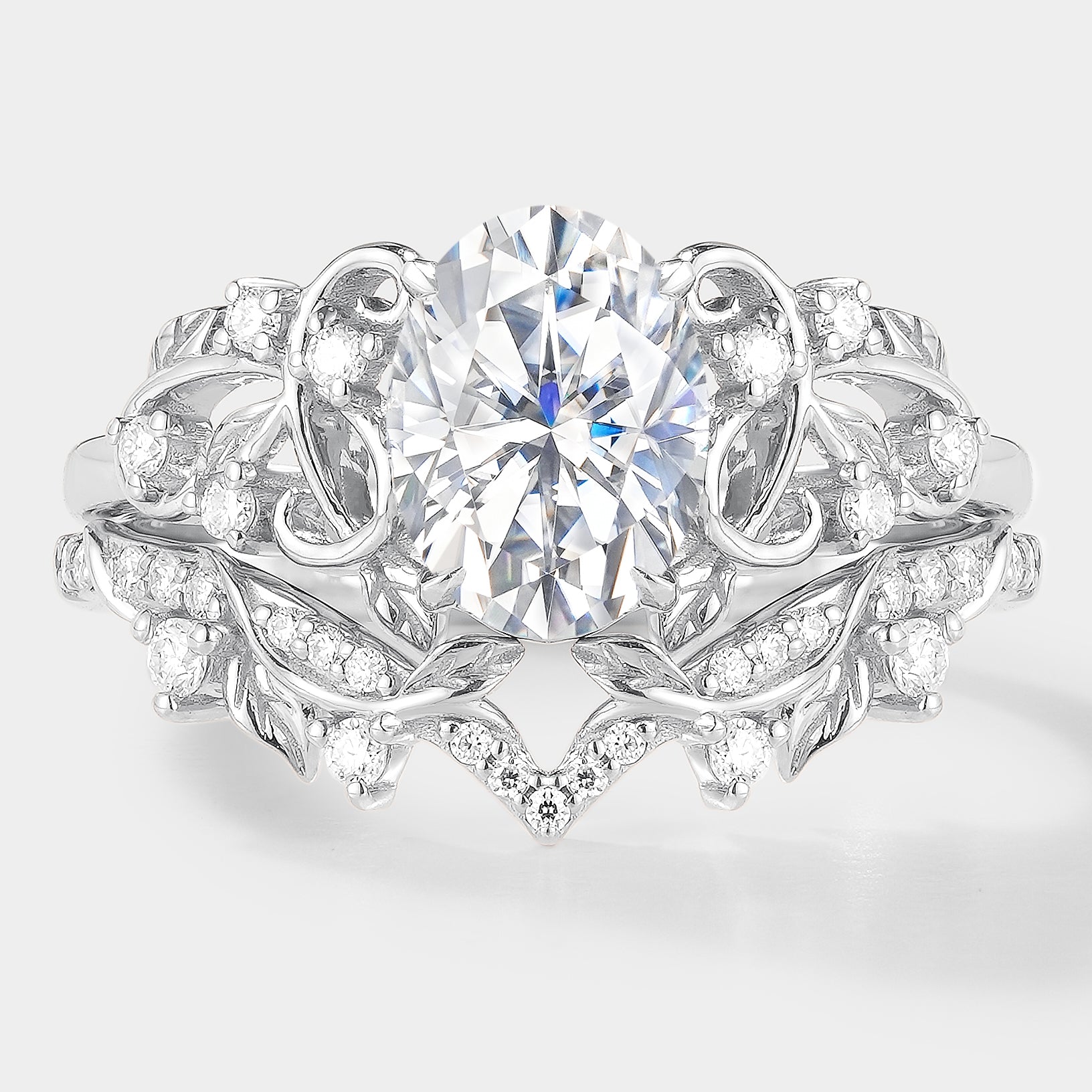 Nature-inspired engagement ring set with oval moissanite and leaf details