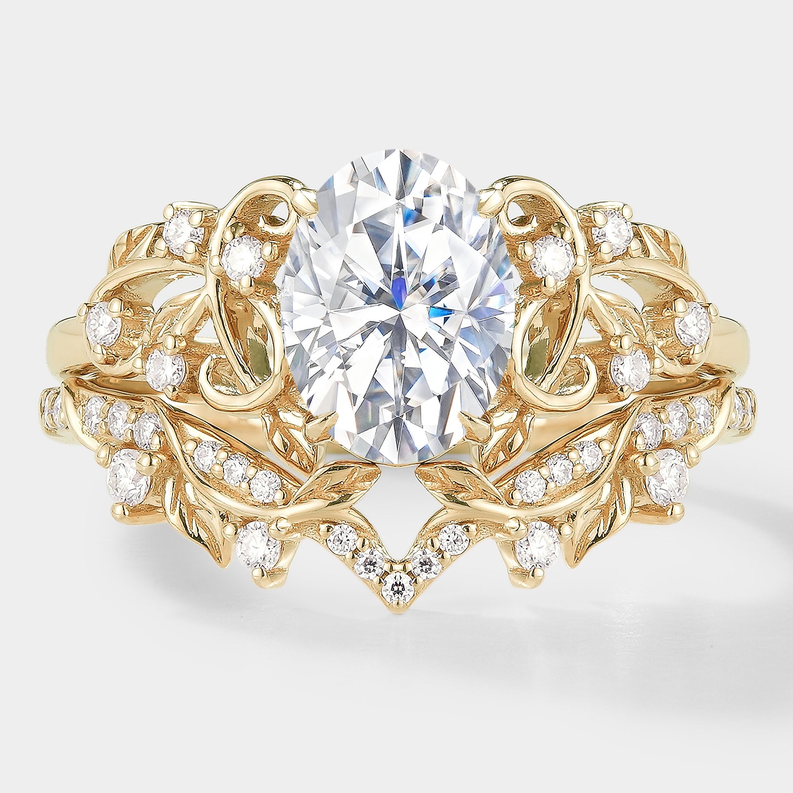 Nature-inspired gold leaf engagement ring set with oval moissanite