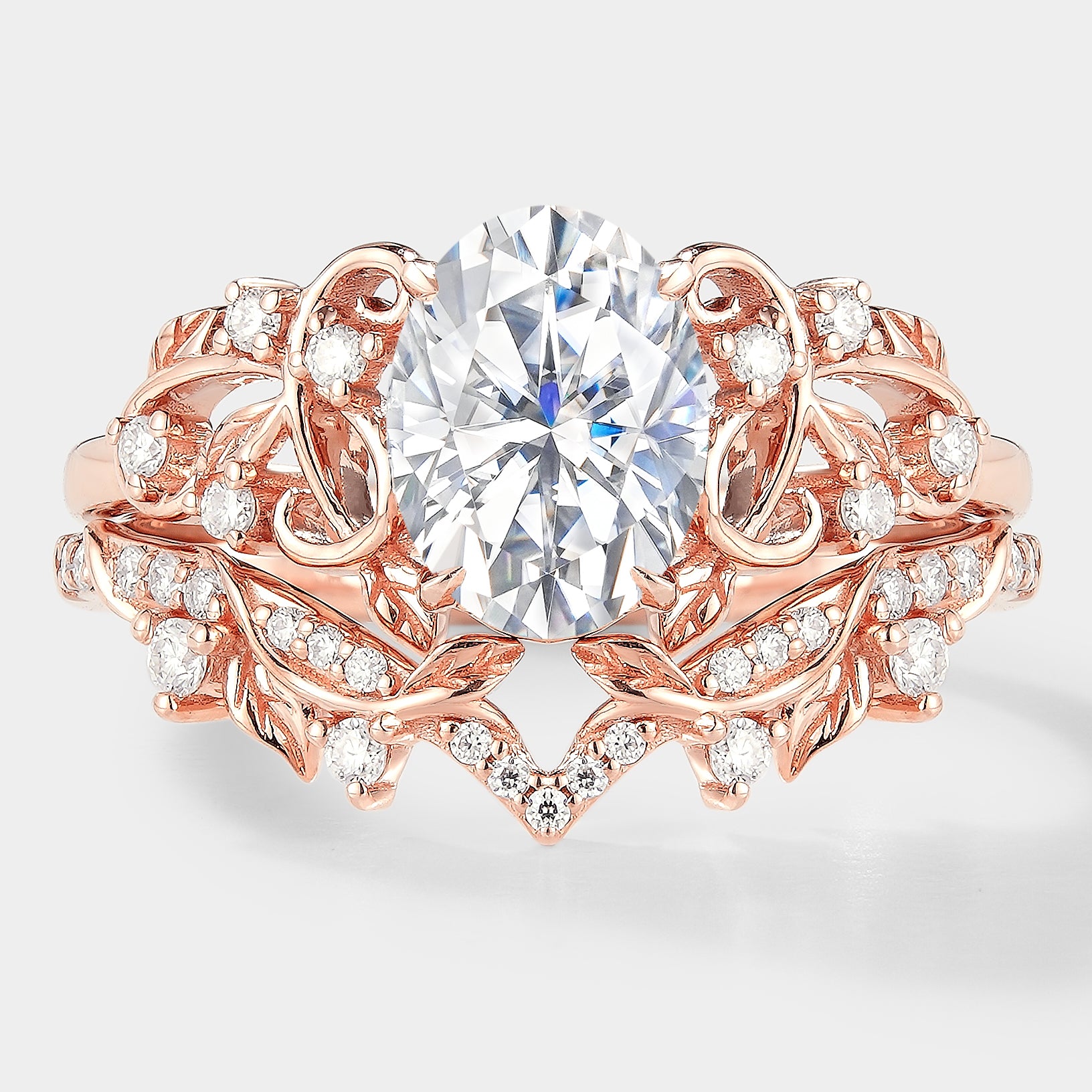 Nature-inspired leaf engagement ring set with oval moissanite