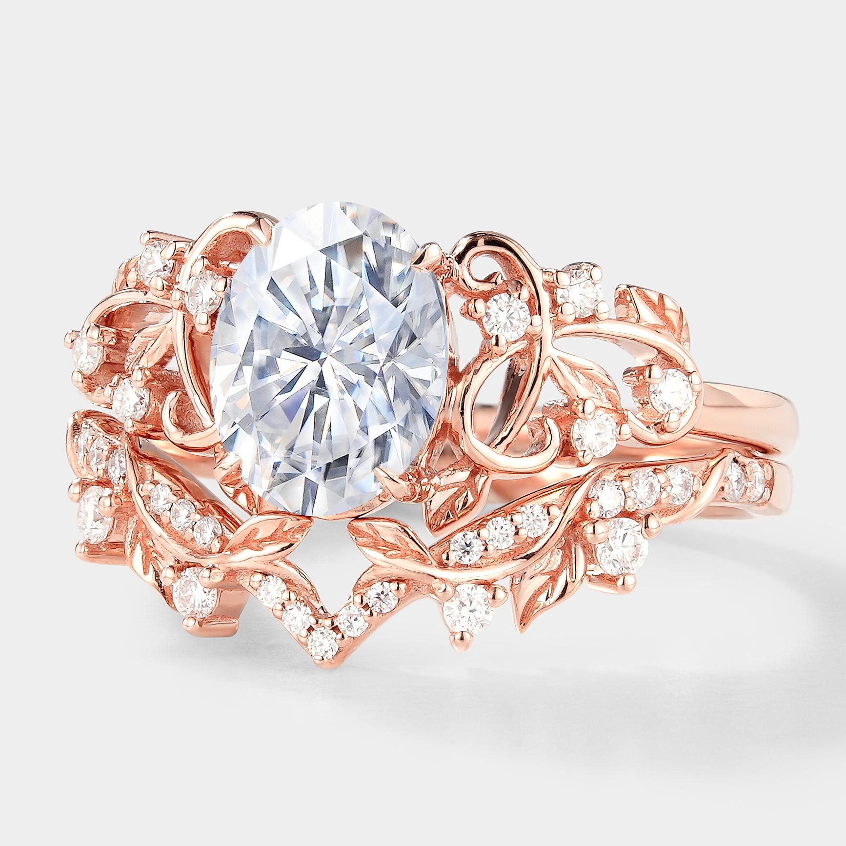 Rose gold leaf engagement ring set with oval moissanite and side stones