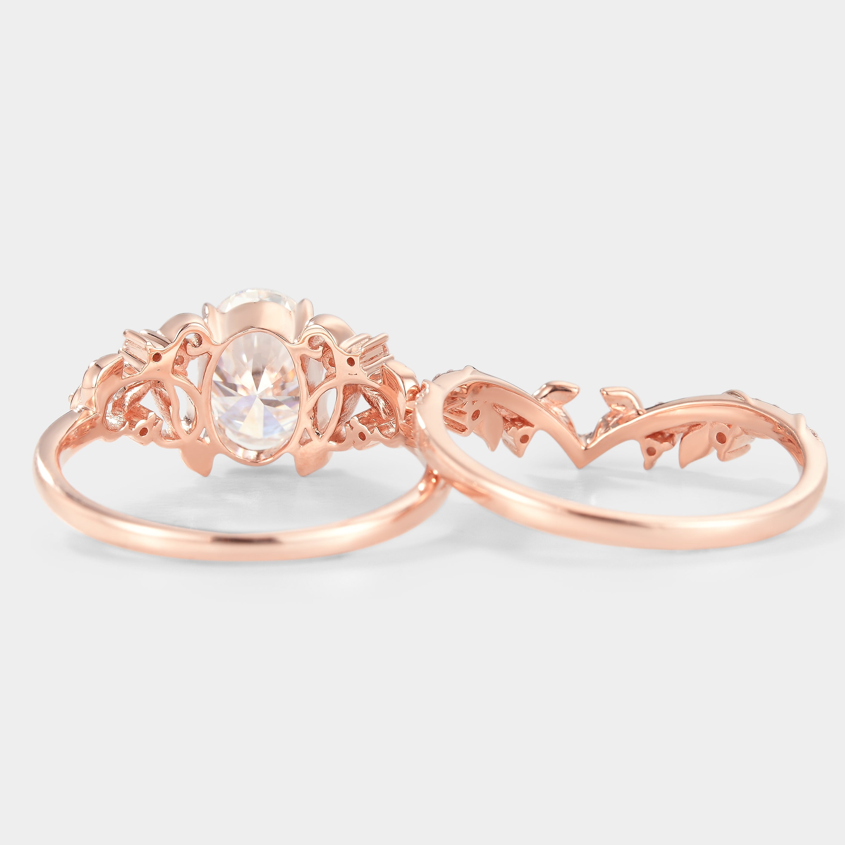 Rose gold nature-inspired engagement ring set with oval moissanite and leaf details