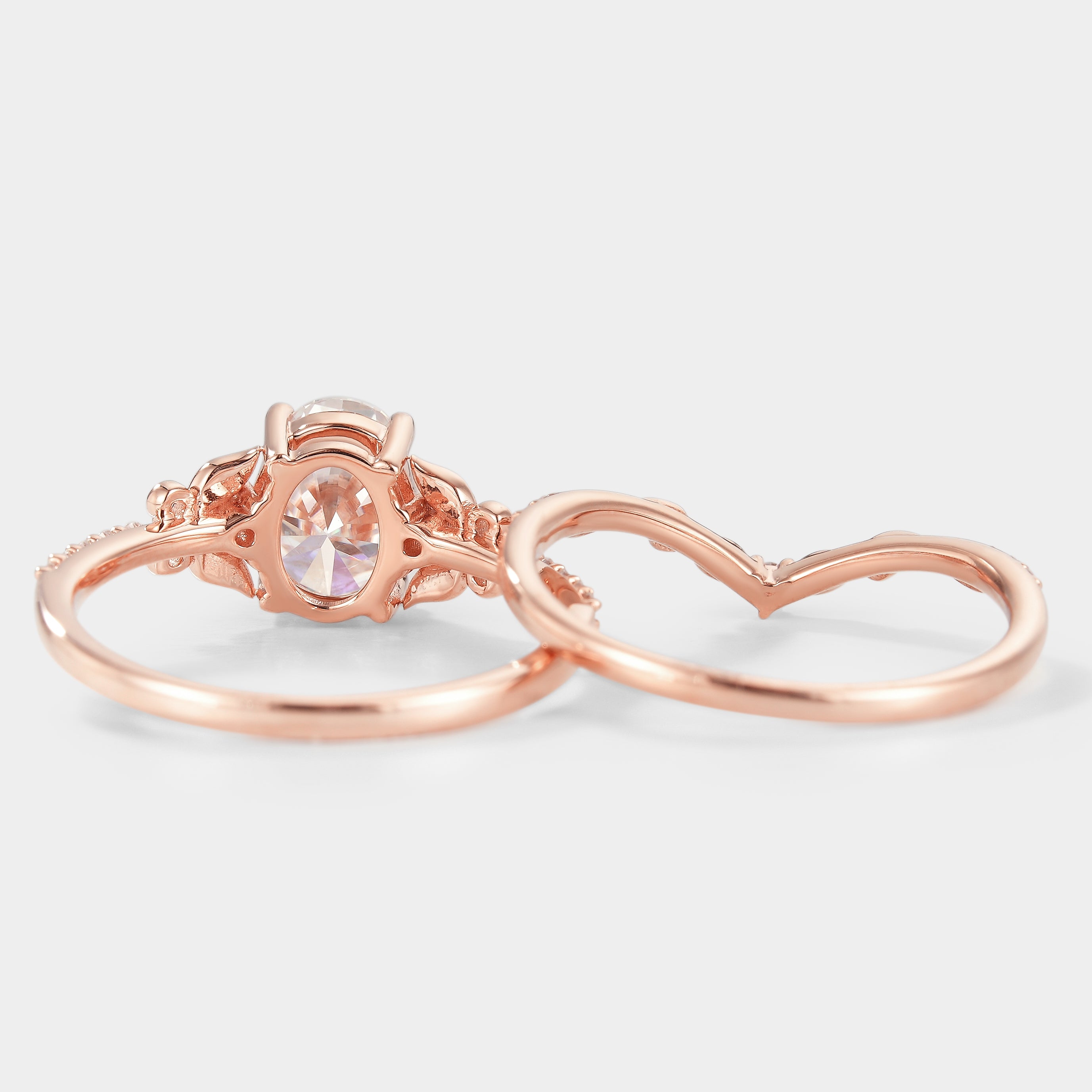 Rose gold oval moissanite engagement ring set with leaf details