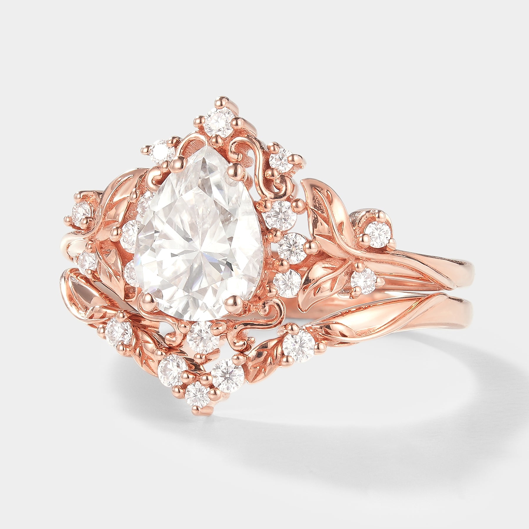 Rose gold leaf-inspired pear cut moissanite engagement ring set