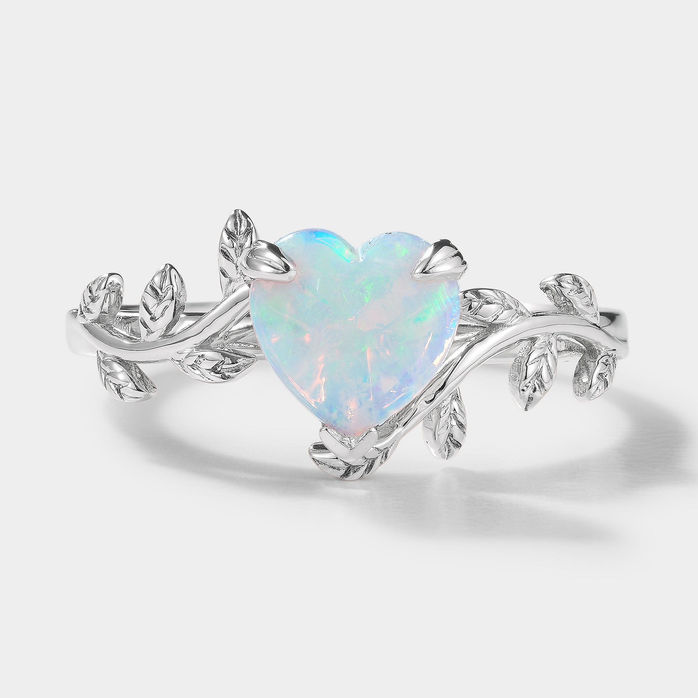 Silver heart-shaped opal ring with leaf design